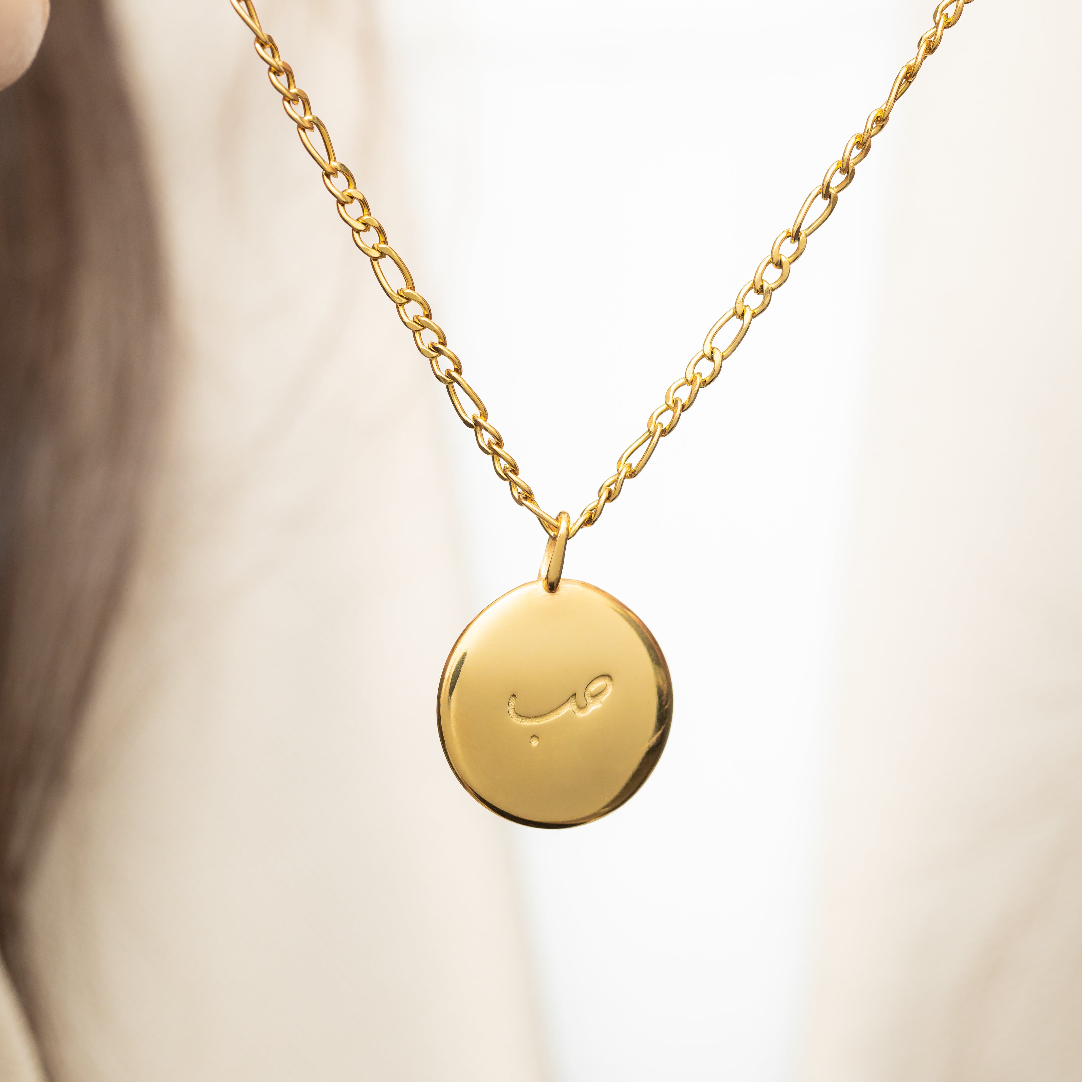 Close-up of the gold charm highlighting its hypoallergenic properties.