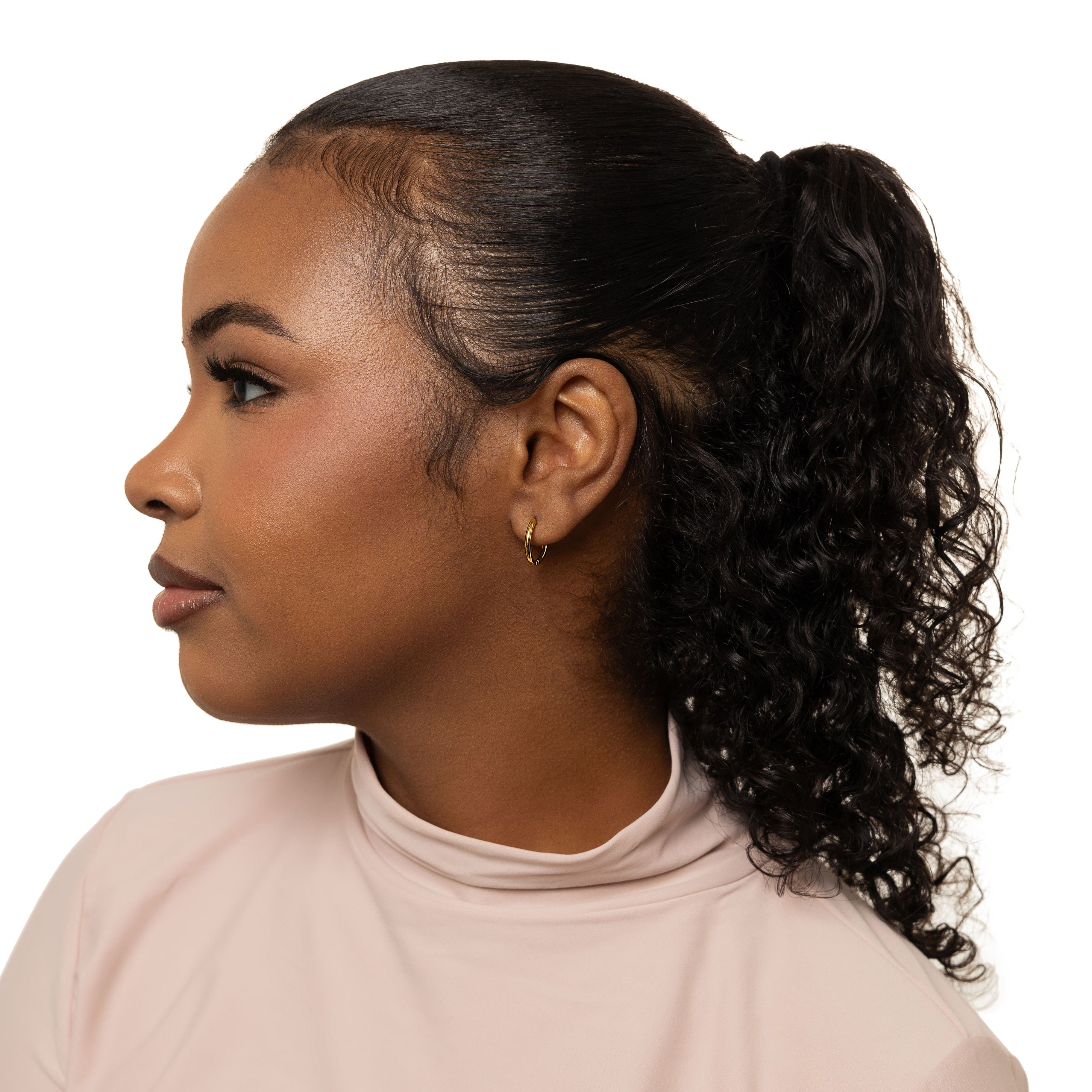 Stacked arrangement of stackable gold huggie earrings for women, demonstrating versatility and style.