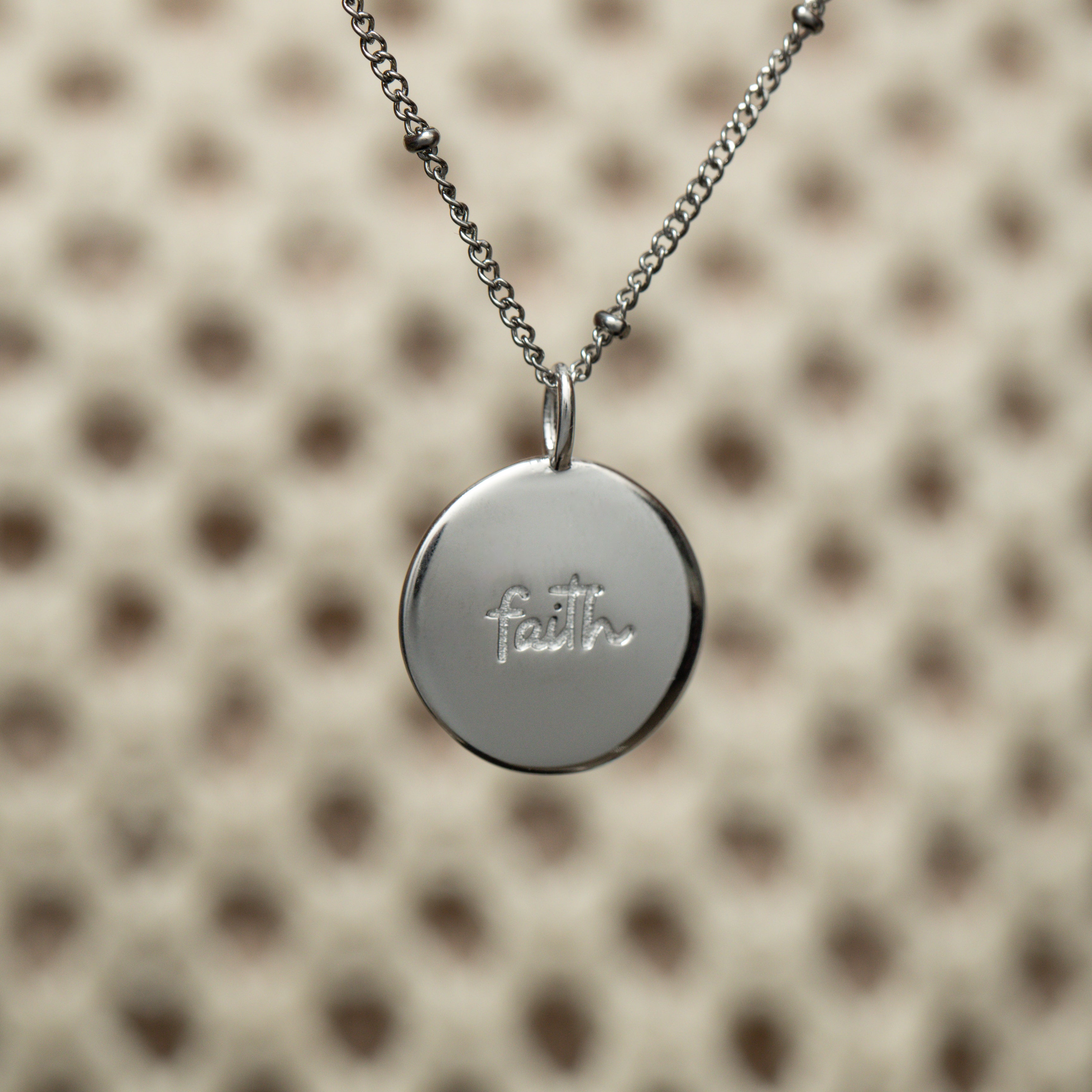 Iman Faith Charm styled on a delicate necklace, perfect for everyday wear.