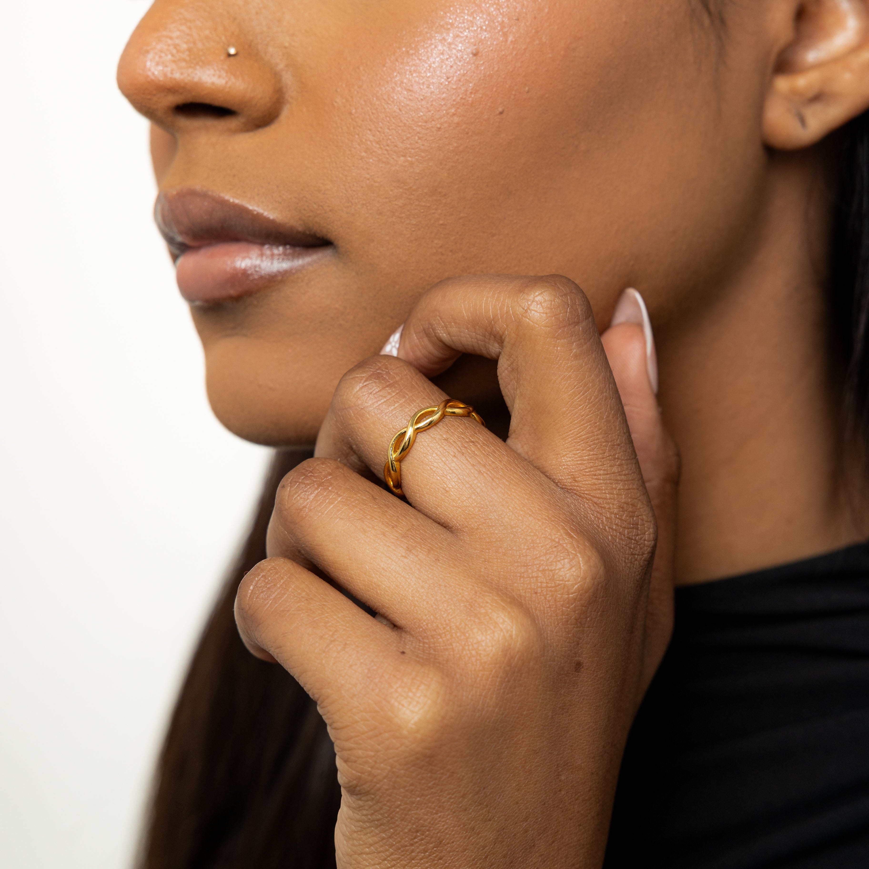 EternaGlow ring stacked with other minimalist gold rings for a layered look