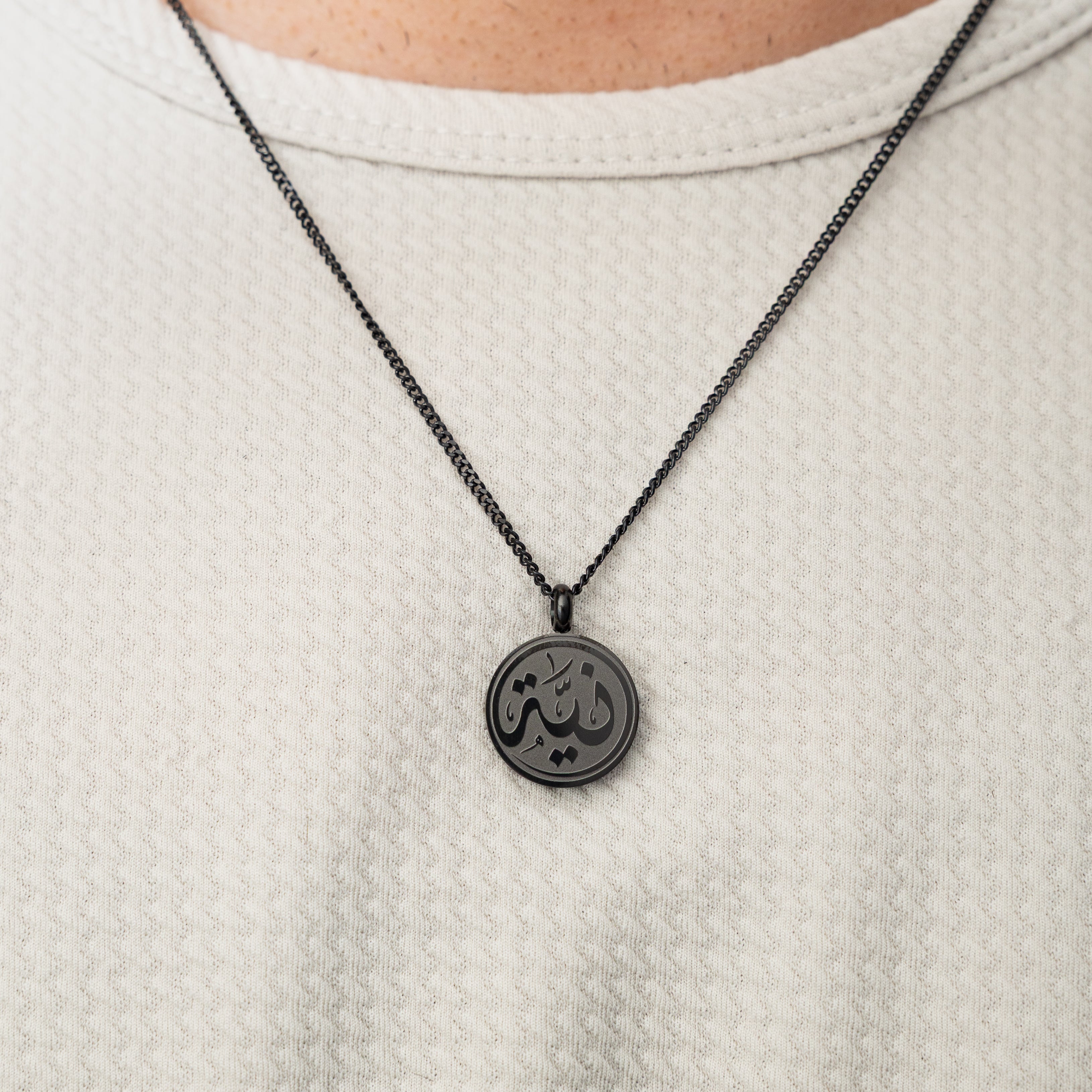Model wearing hypoallergenic mens necklace with meaning outdoors