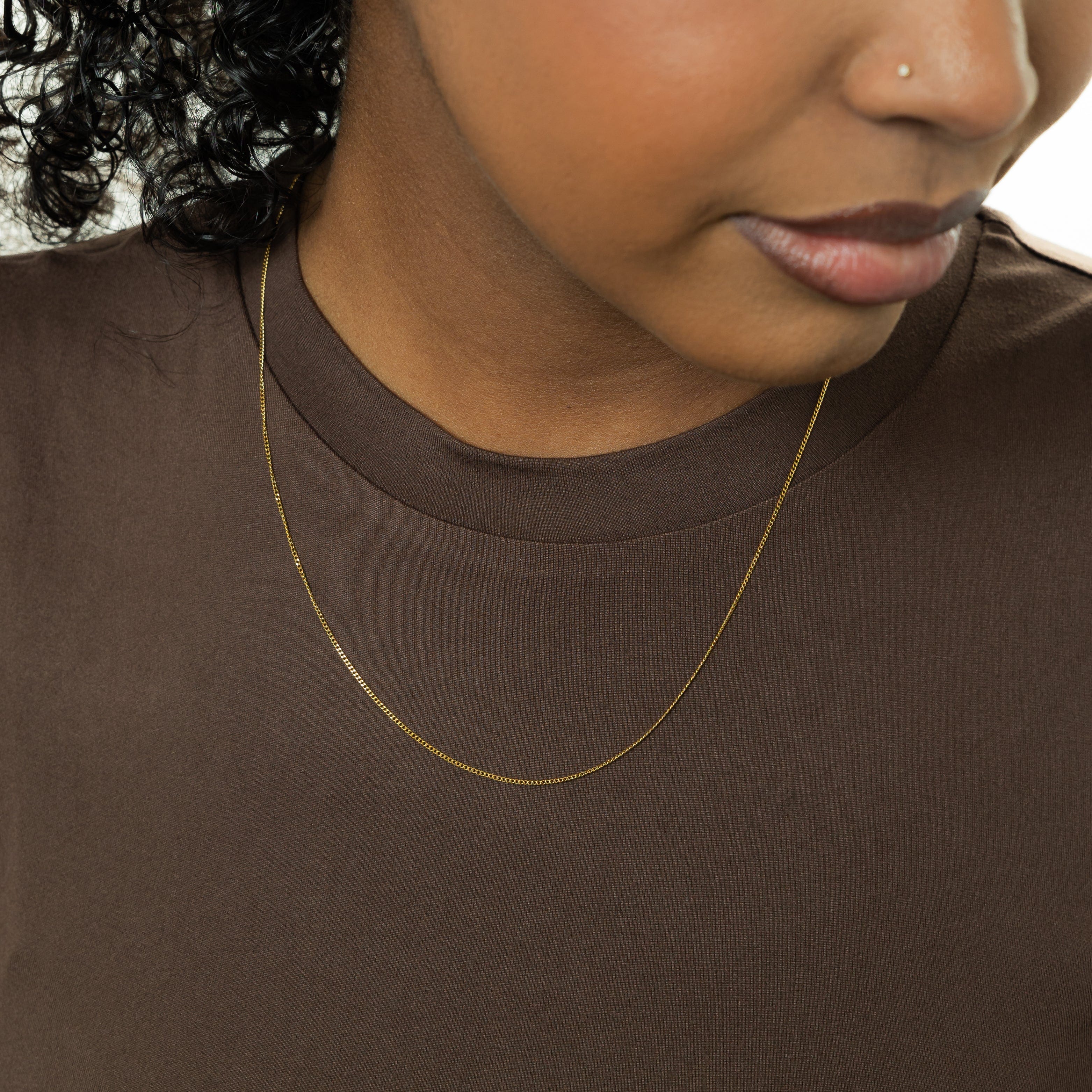 Elegant Invisible Curb Chain Necklace displayed in a velvet pouch, highlighting its premium quality.