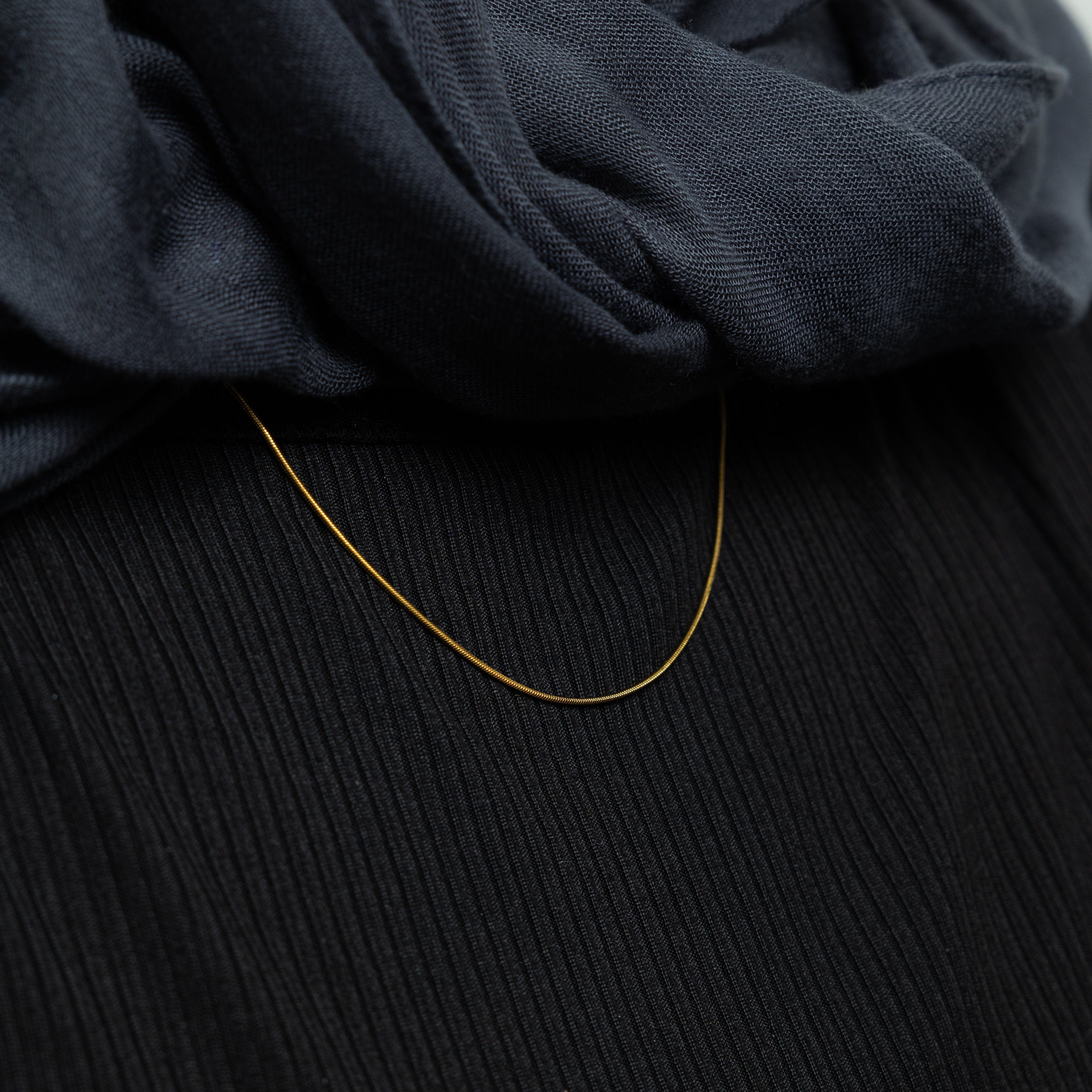 Packaging of the Invisible Elegance Gold Chain in a velvet pouch, emphasizing its premium quality.