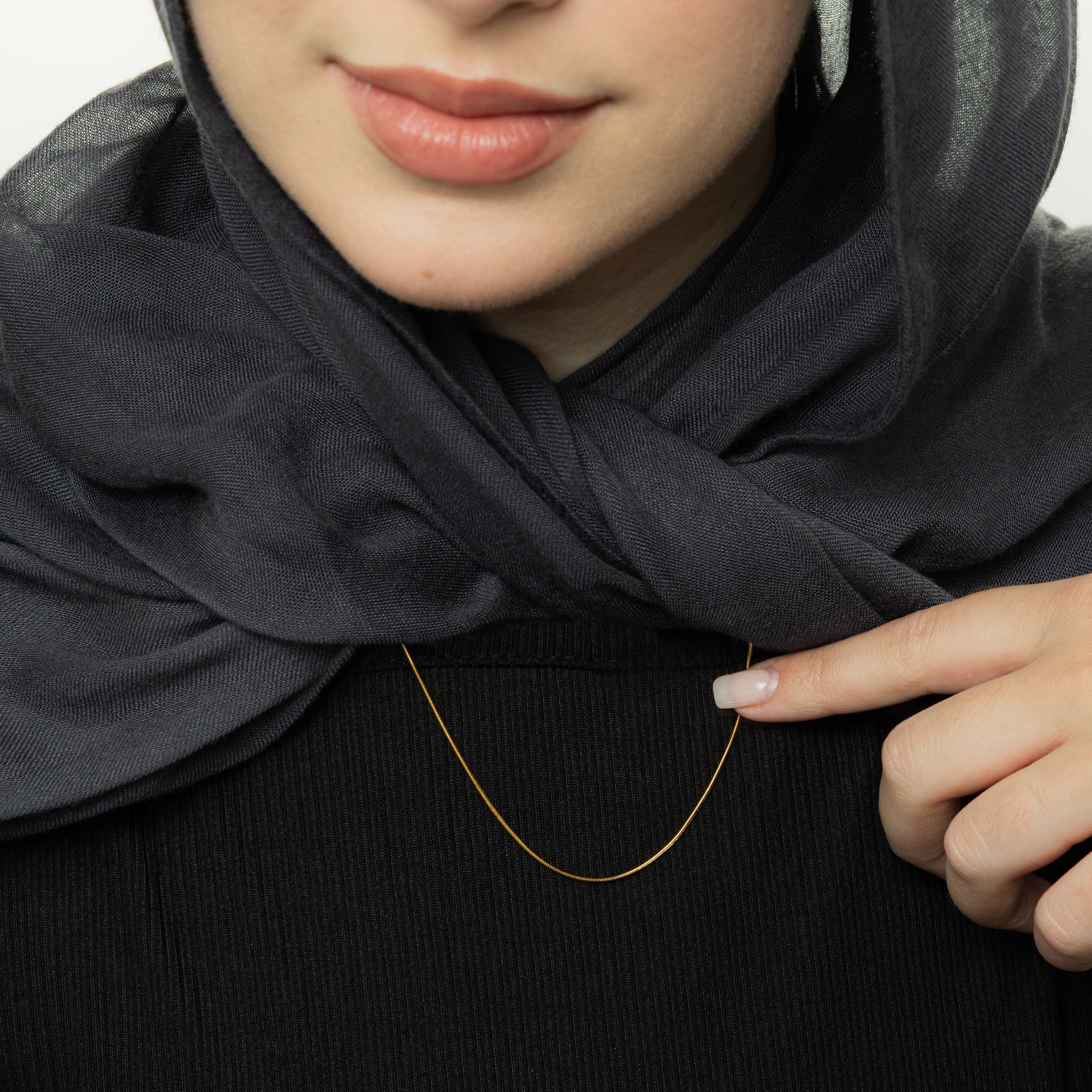 Model wearing the Invisible Elegance Gold Chain at 22 inches, demonstrating its versatile styling options.
