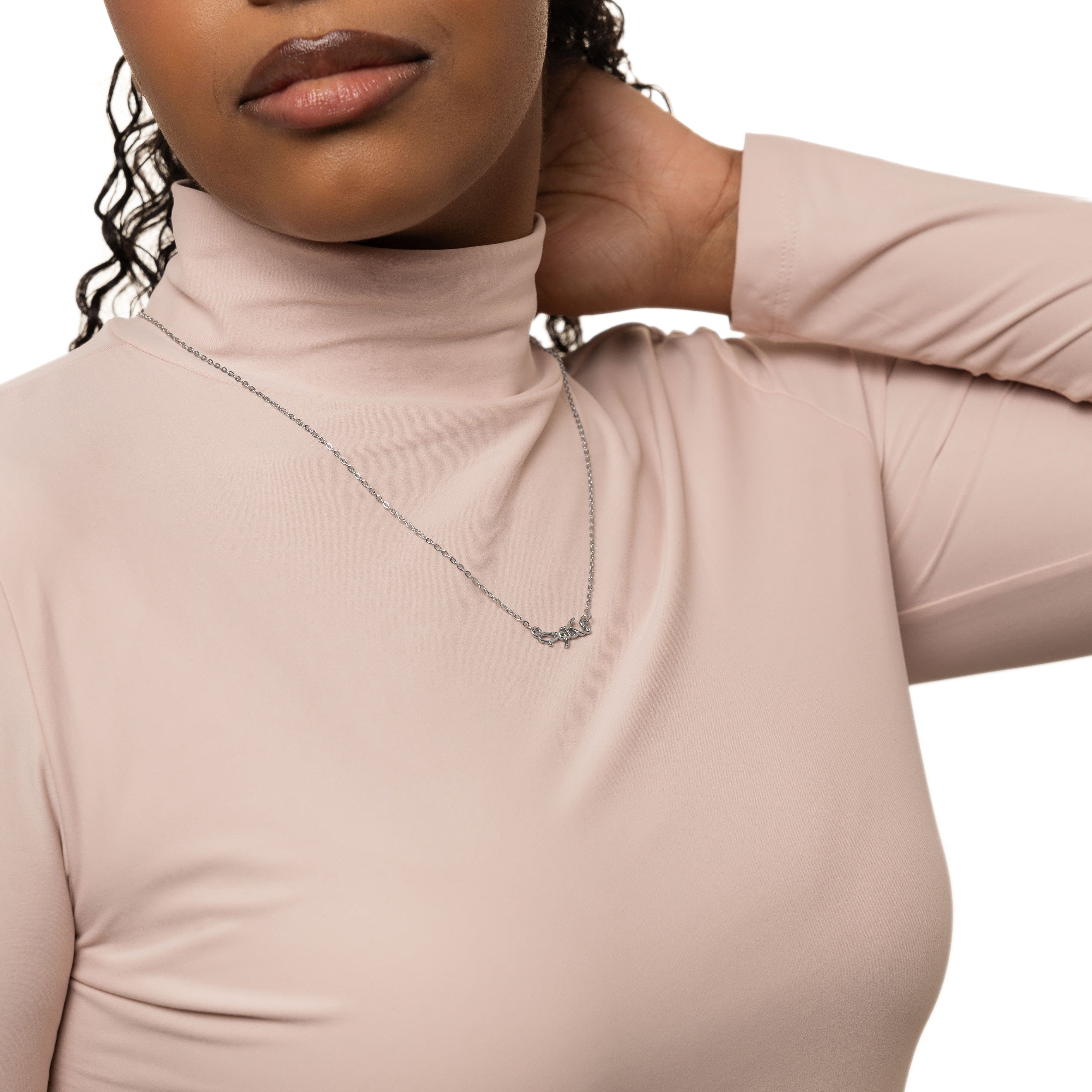Maktub bubble necklace showcasing Arabic calligraphy on a gold-plated chain.