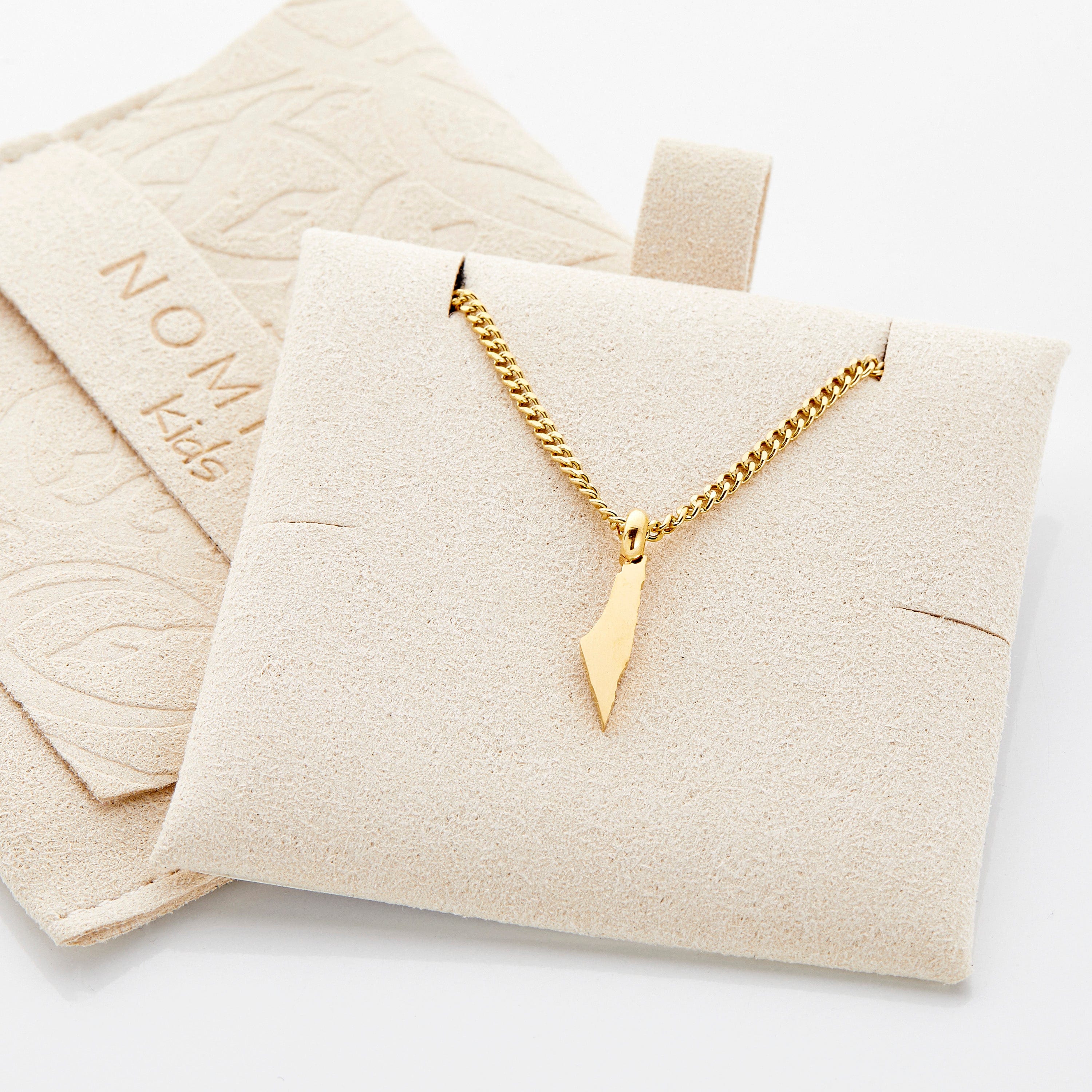 Close-up of a custom gold necklace for kids featuring a hometown map