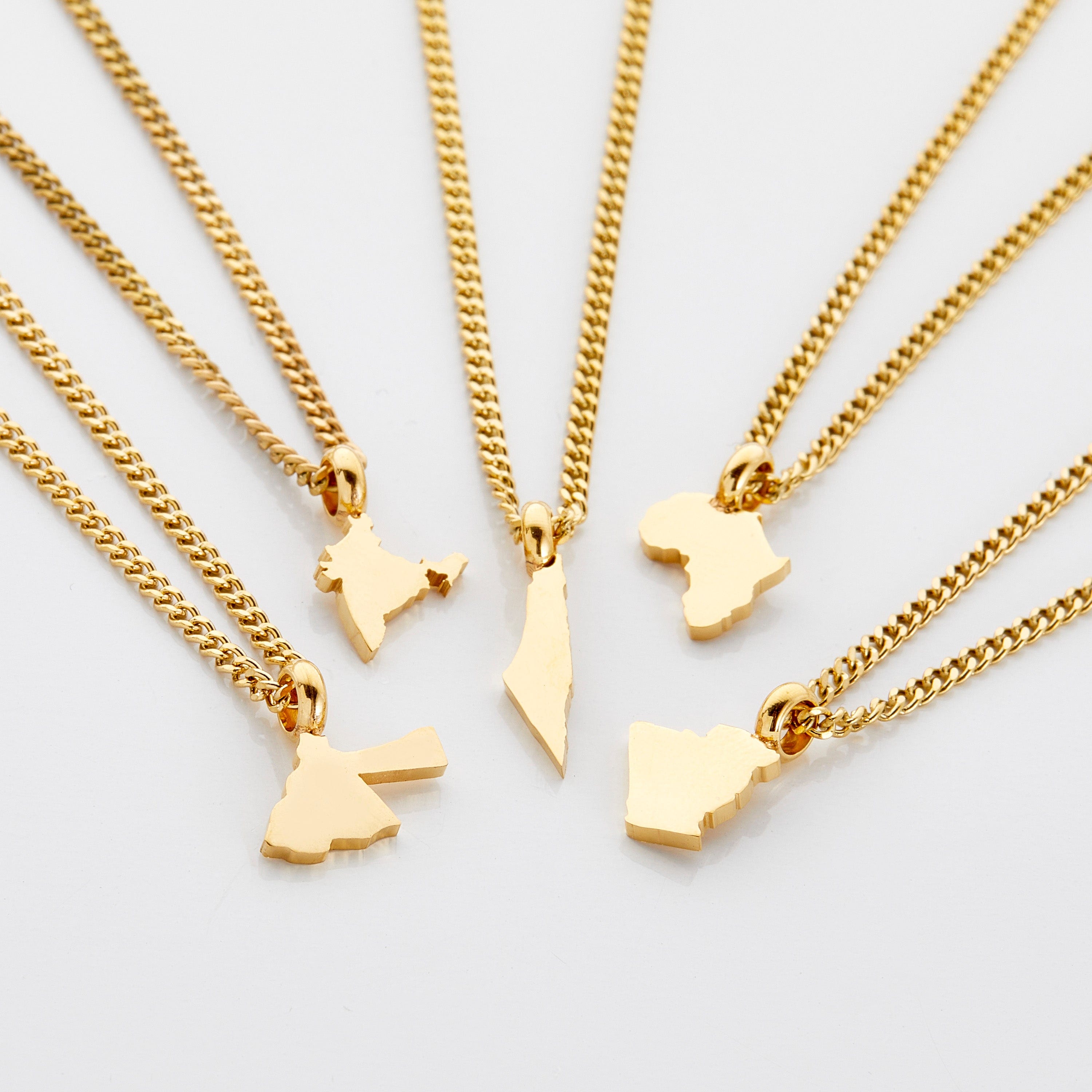 Personalized country map necklace for kids displayed on a velvet pouch