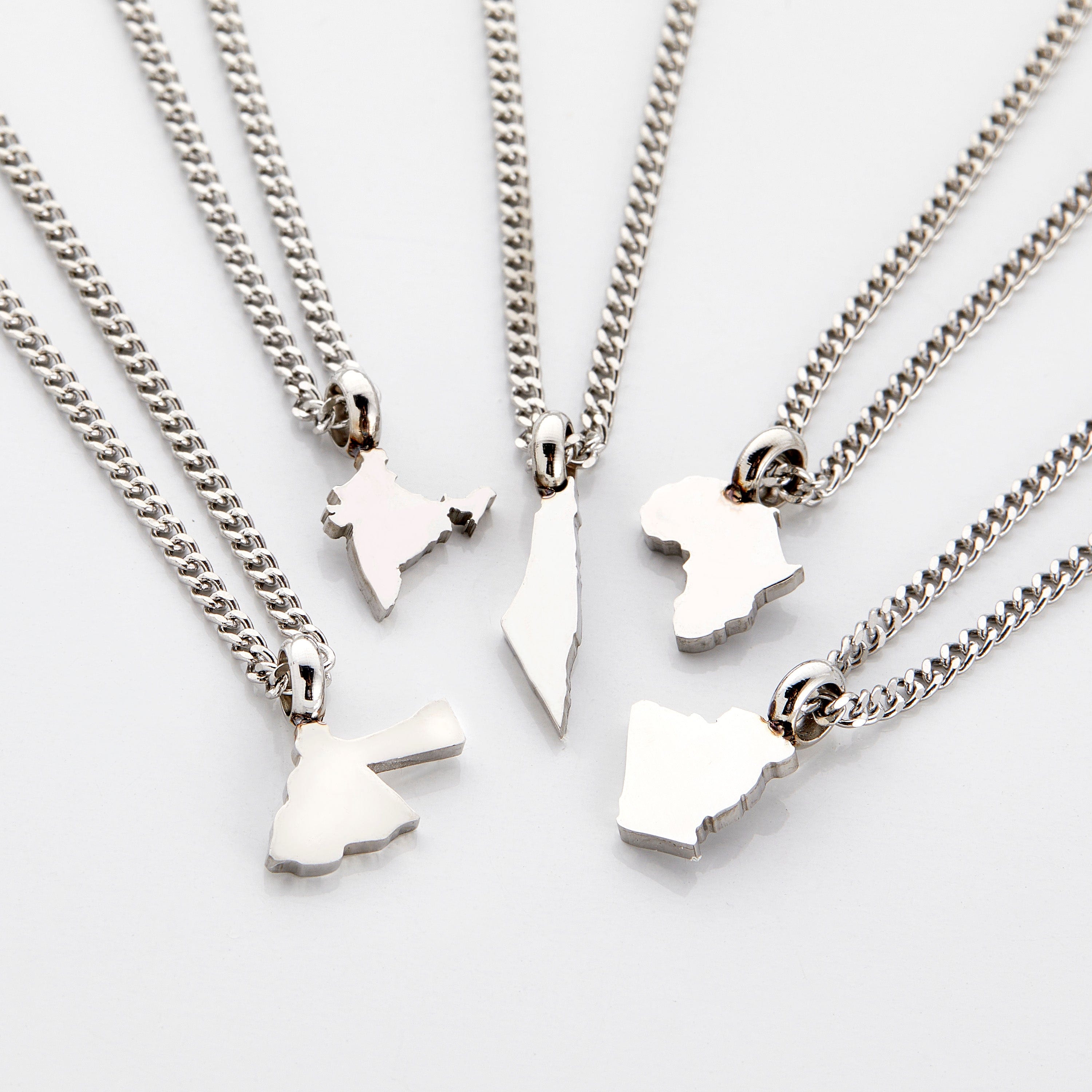 Close-up of a custom gold necklace for kids featuring a hometown map