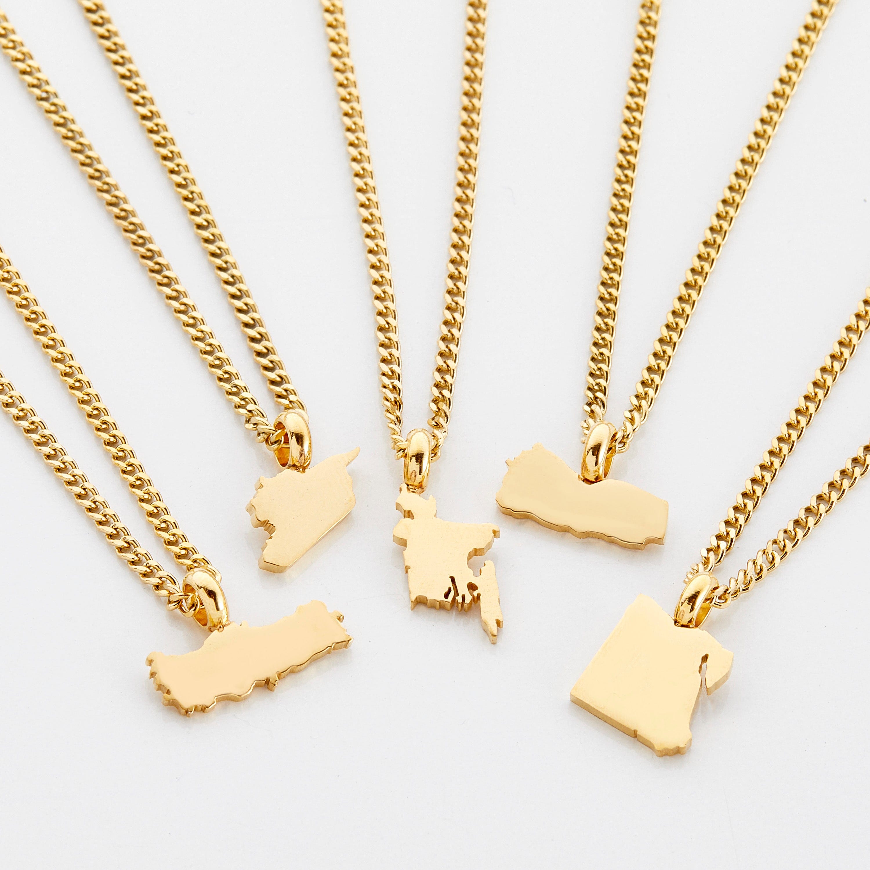 Personalized country map necklace for kids displayed on a velvet pouch