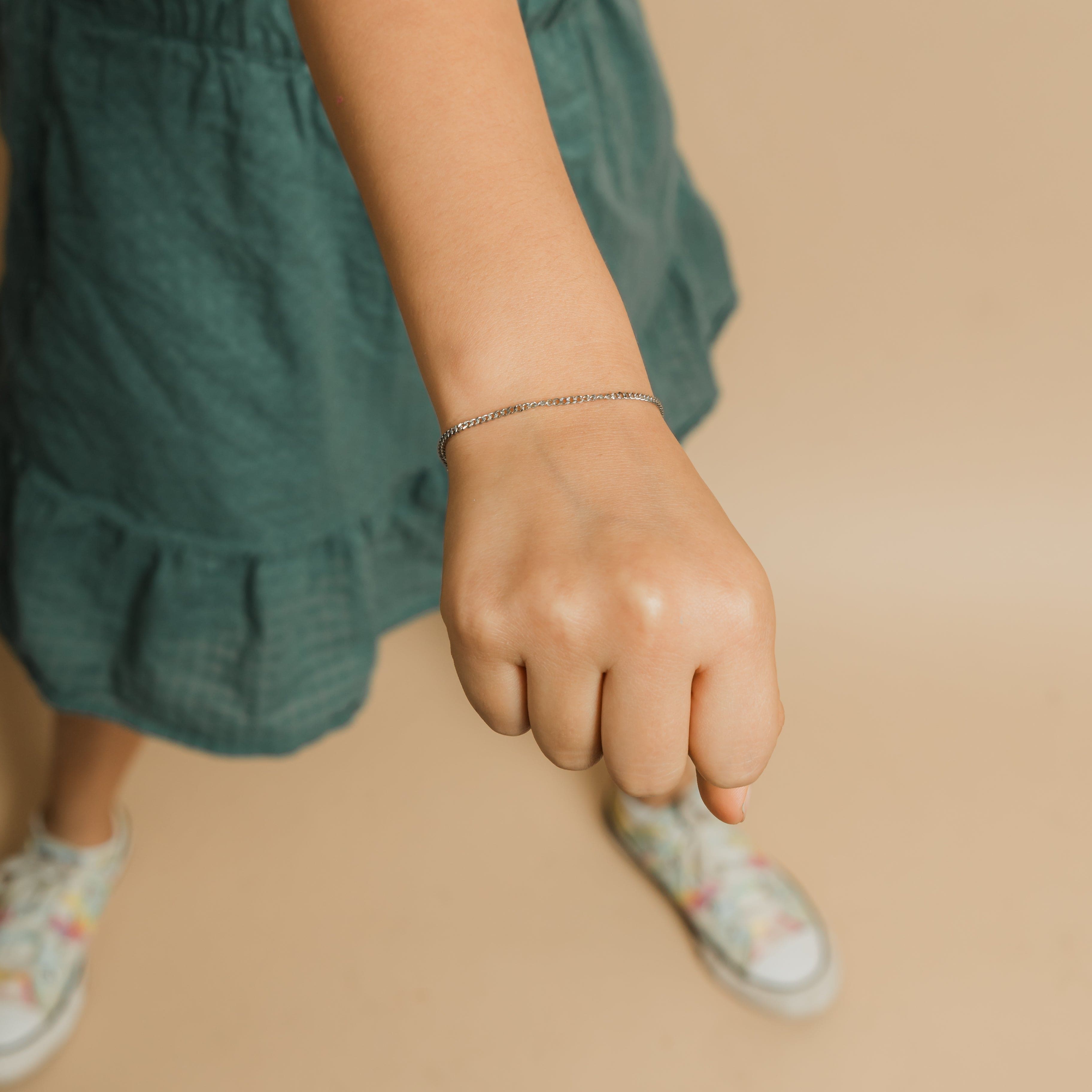 Little girl wearing the waterproof girls bracelet with warranty while playing outside.