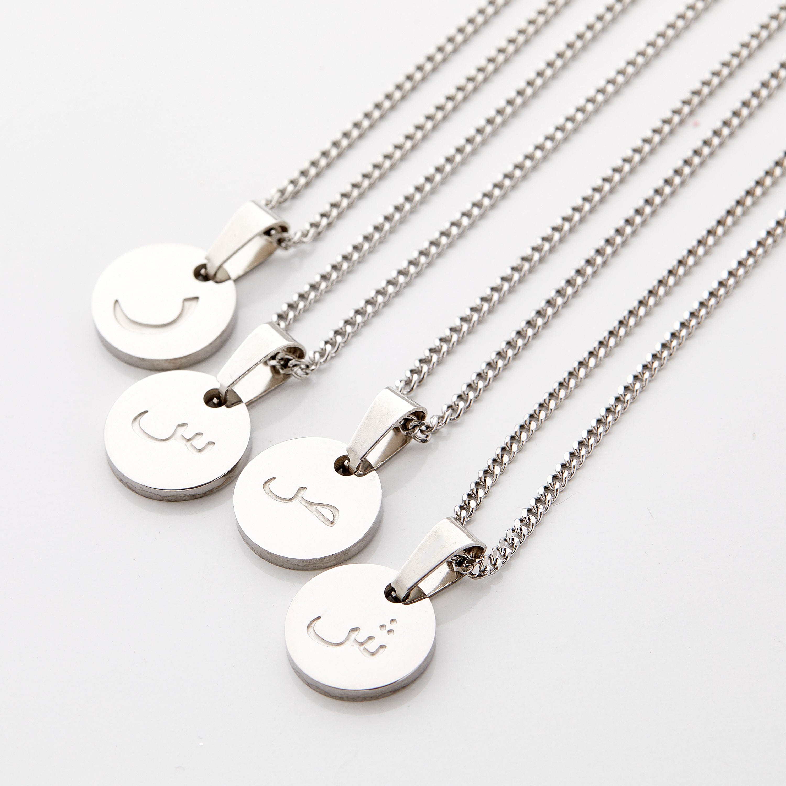 Young boy wearing the trendy letter necklace, showcasing how it complements his outfit.