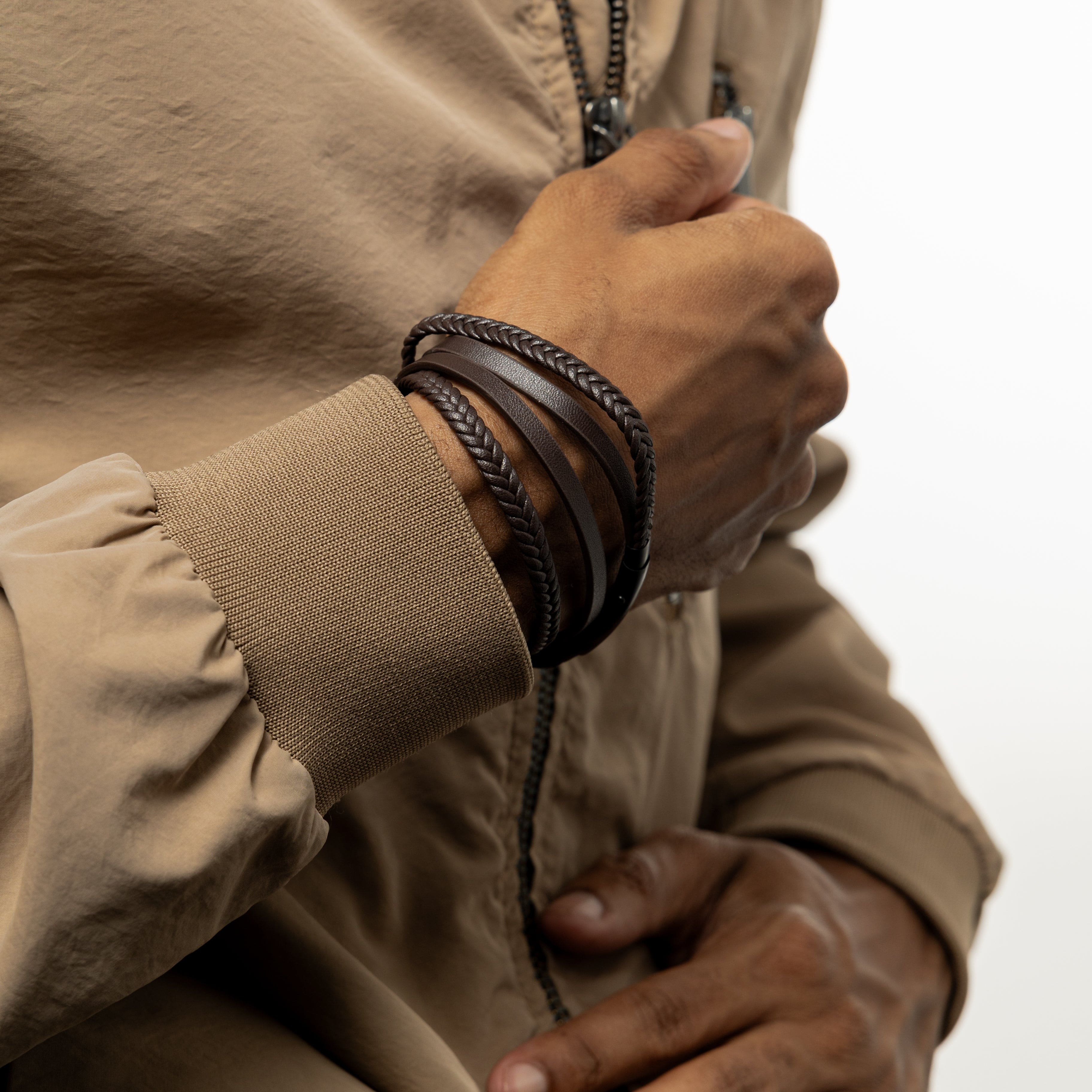 Flat lay image featuring Nominal velvet pouch next to black stacked leather bracelet