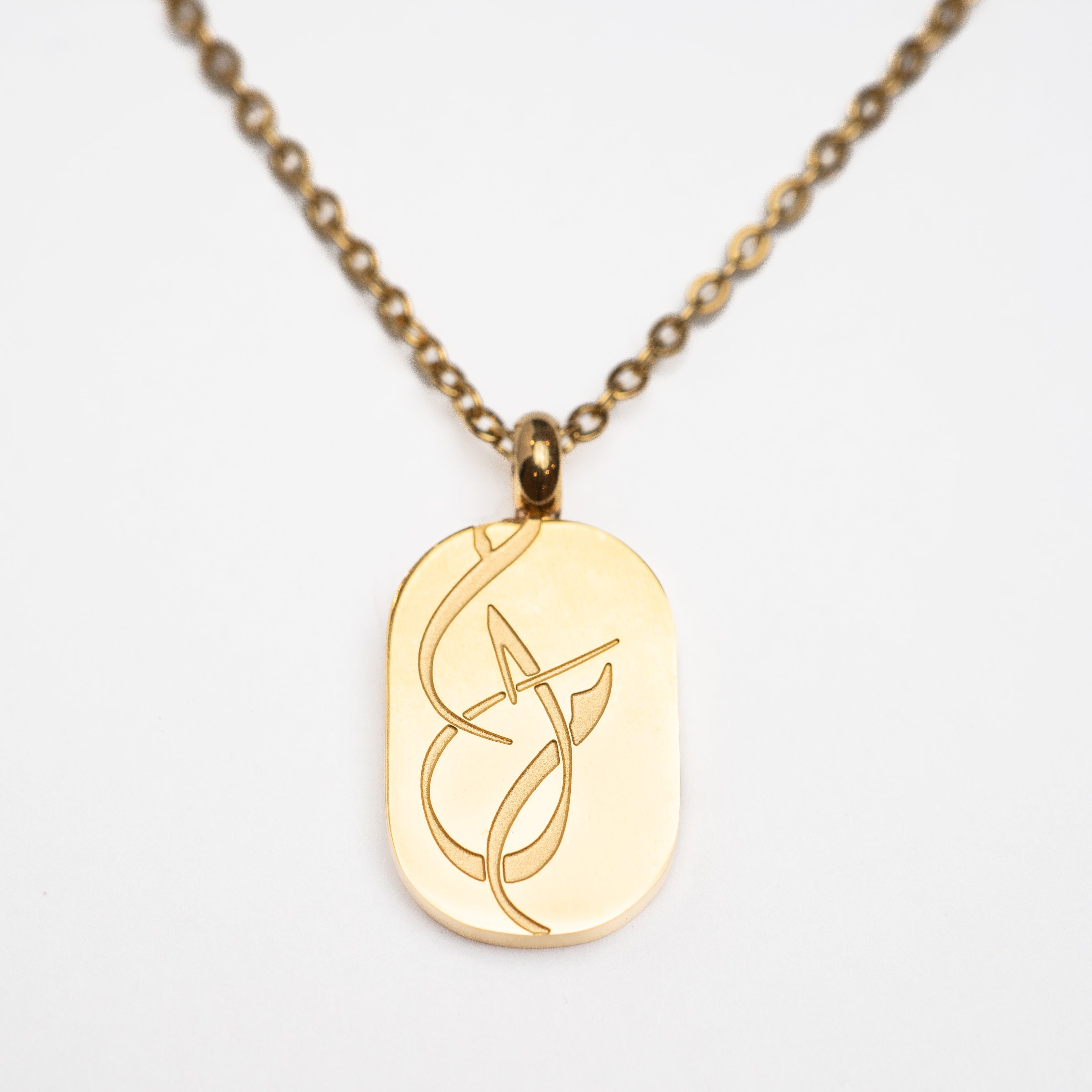 Close-up of the Dotted Chain and Dream pendant, highlighting the gold plating and intricate design.