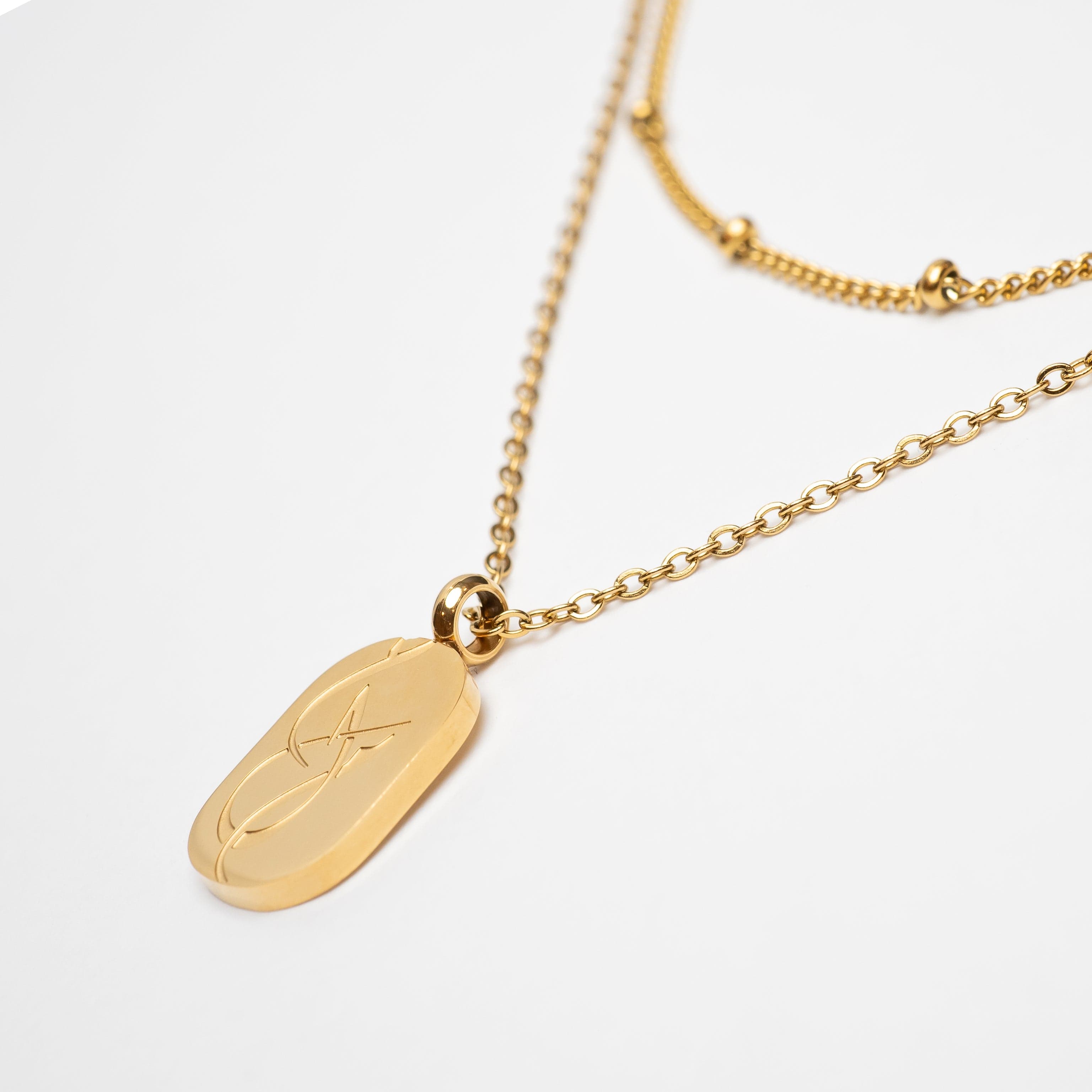 Close-up of the Dotted Chain and Dream pendant, highlighting the gold plating and intricate design.