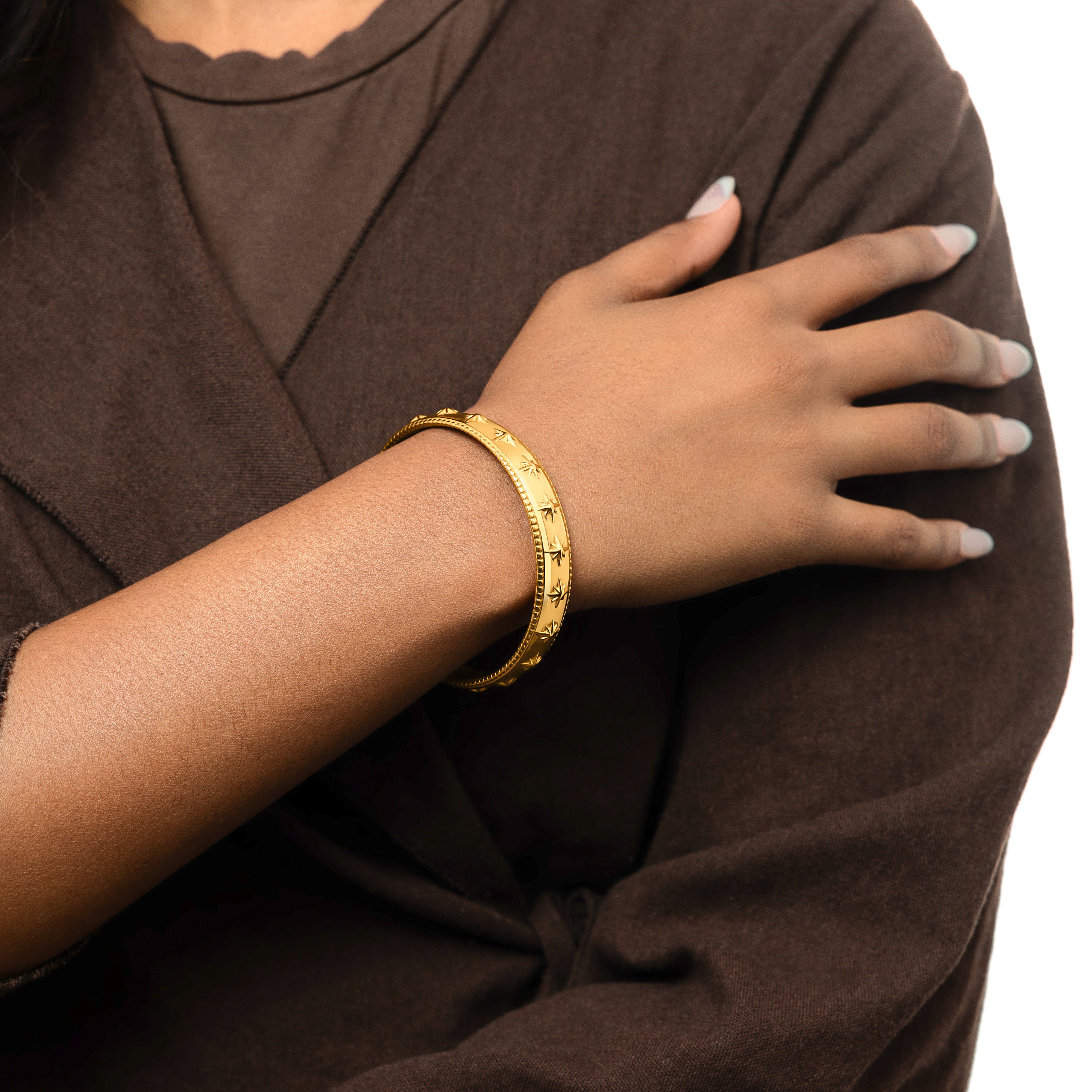 Close-up view of the Eternal Impact Bangle highlighting the embossed Xs.