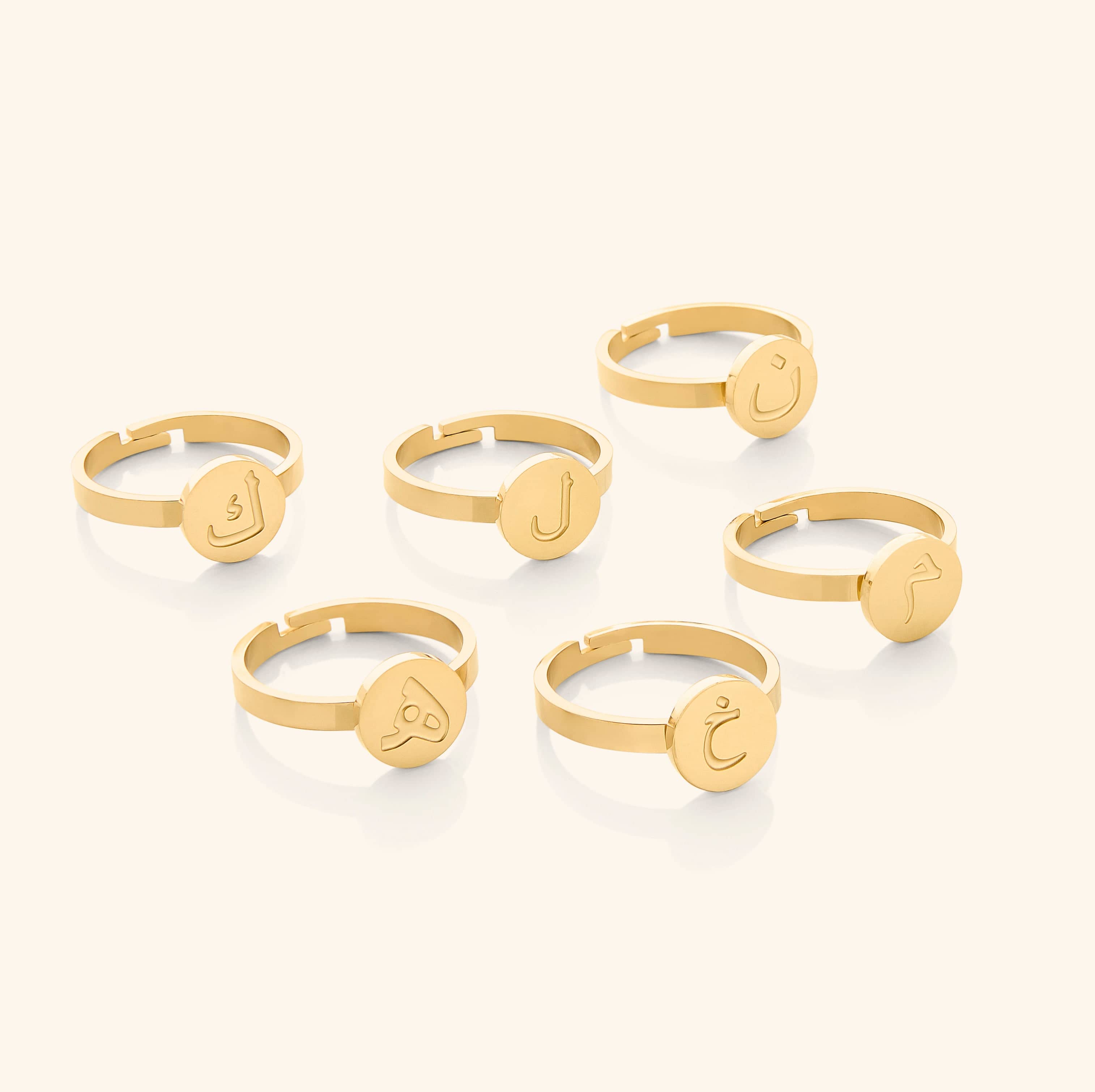 Personalized letter ring displayed in a velvet pouch.