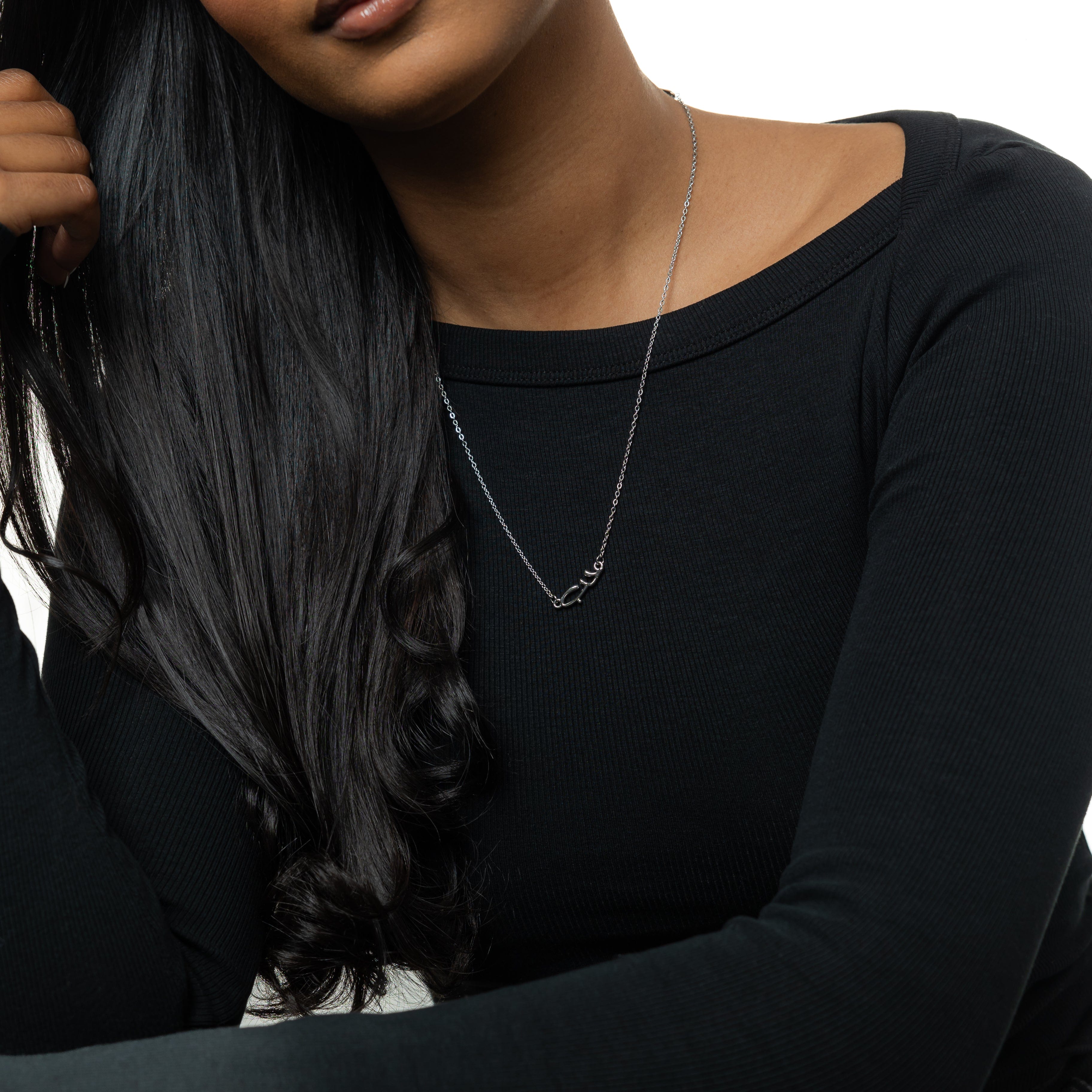 Necklace displayed on a velvet pouch, emphasizing the elegant packaging.