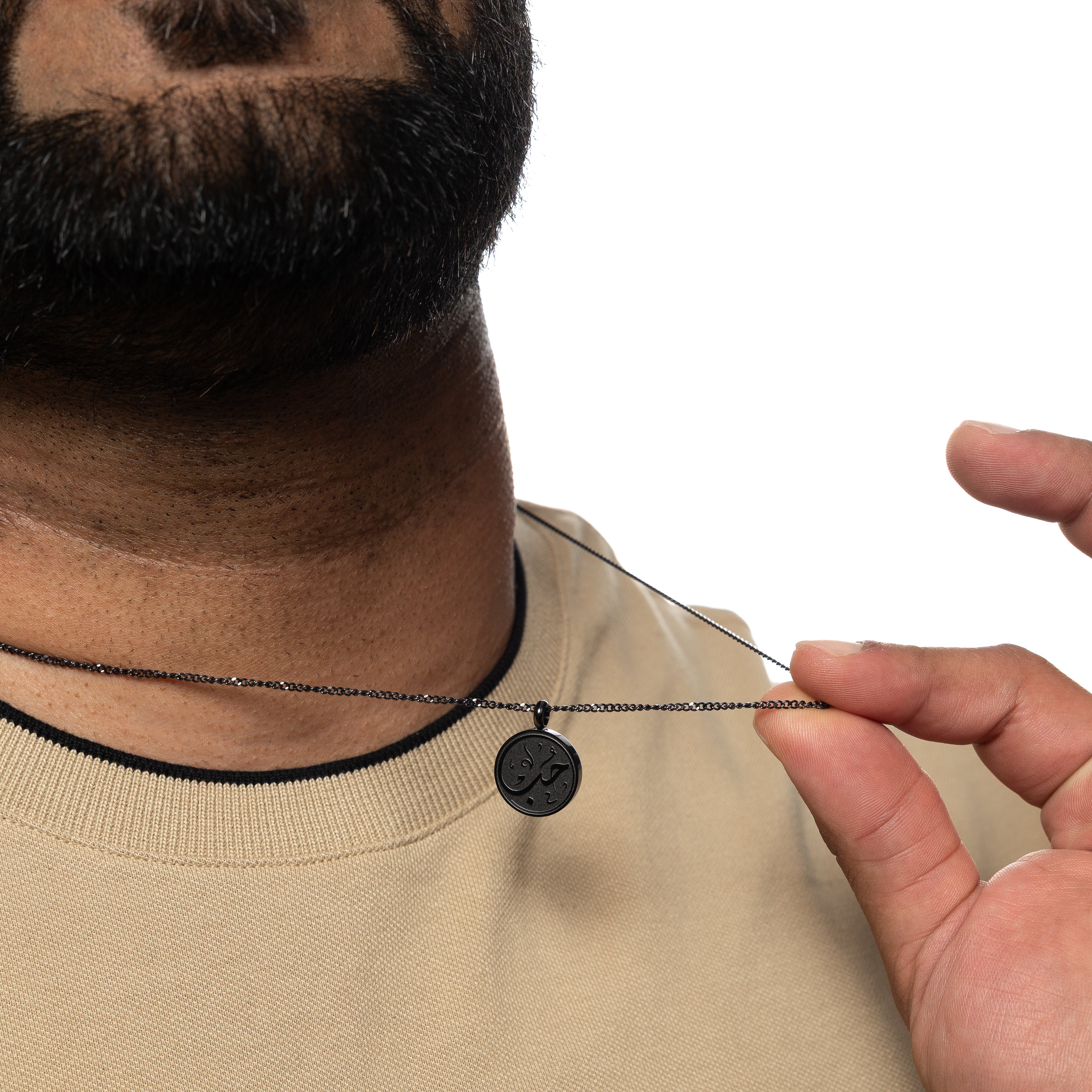 Mens jewelry featuring the Arabic calligraphy love necklace worn on a model, highlighting its appeal.