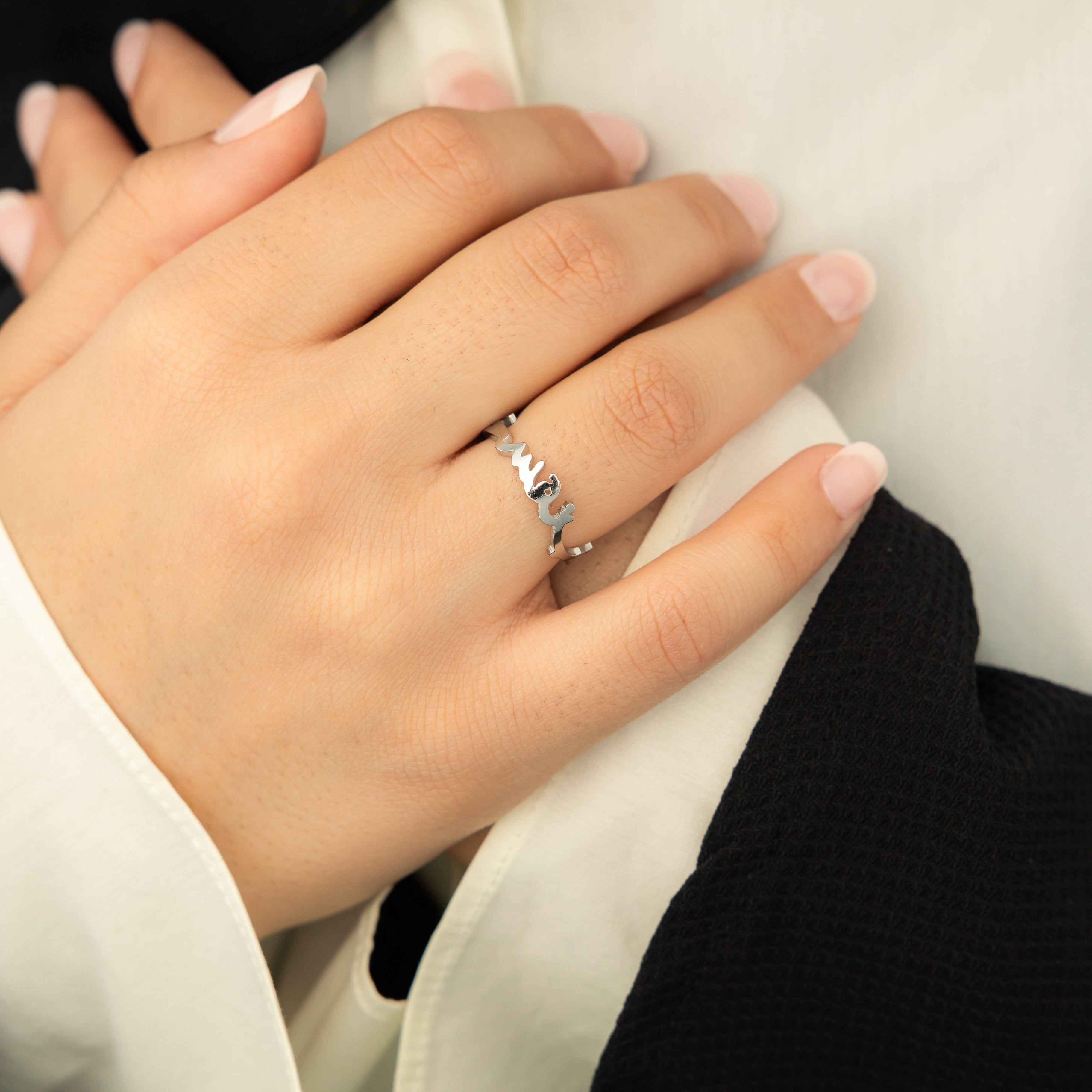 Close-up of the gold ring with Arabic script, emphasizing quality and craftsmanship.