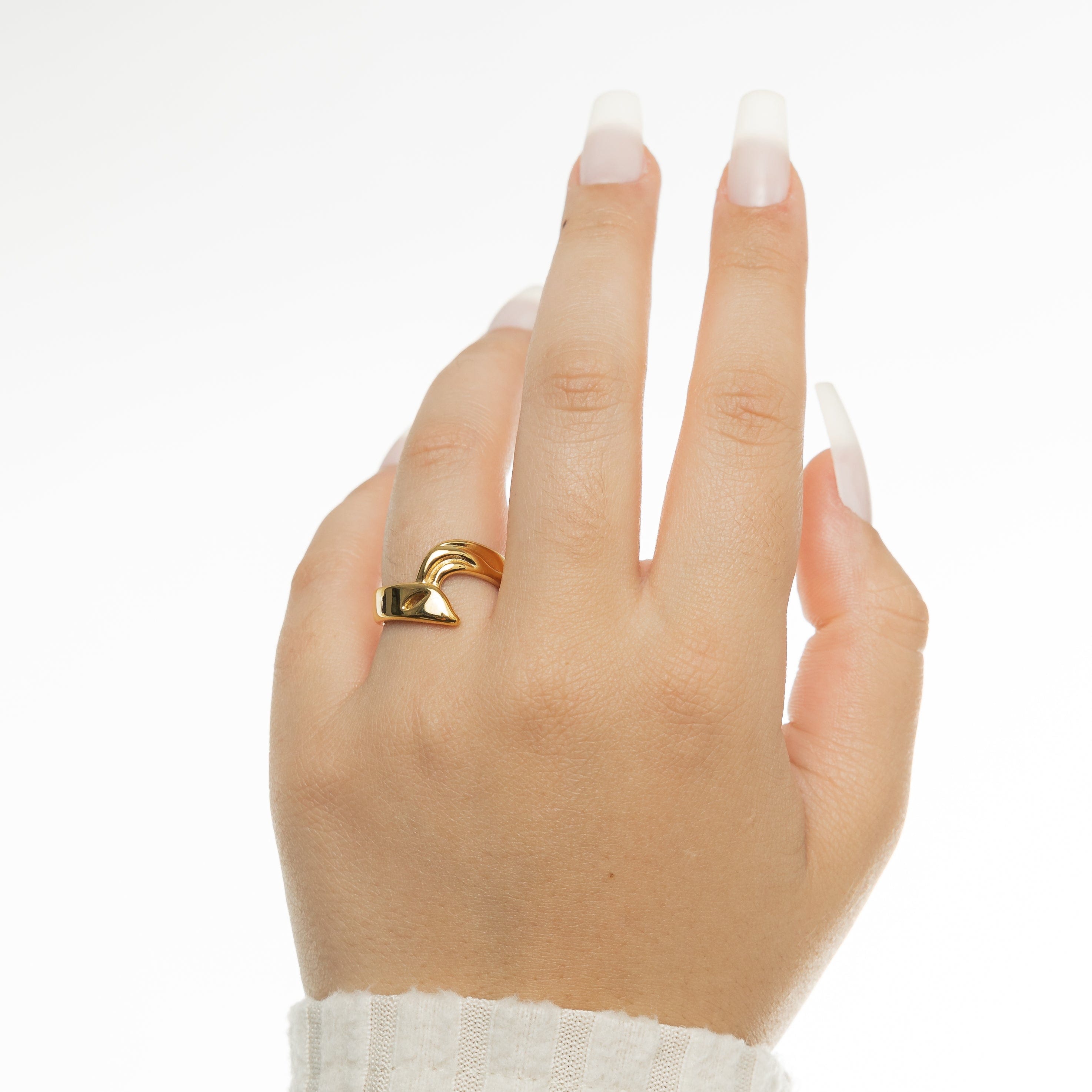 Close-up of the 18K gold love ring, highlighting its shiny finish and detail.