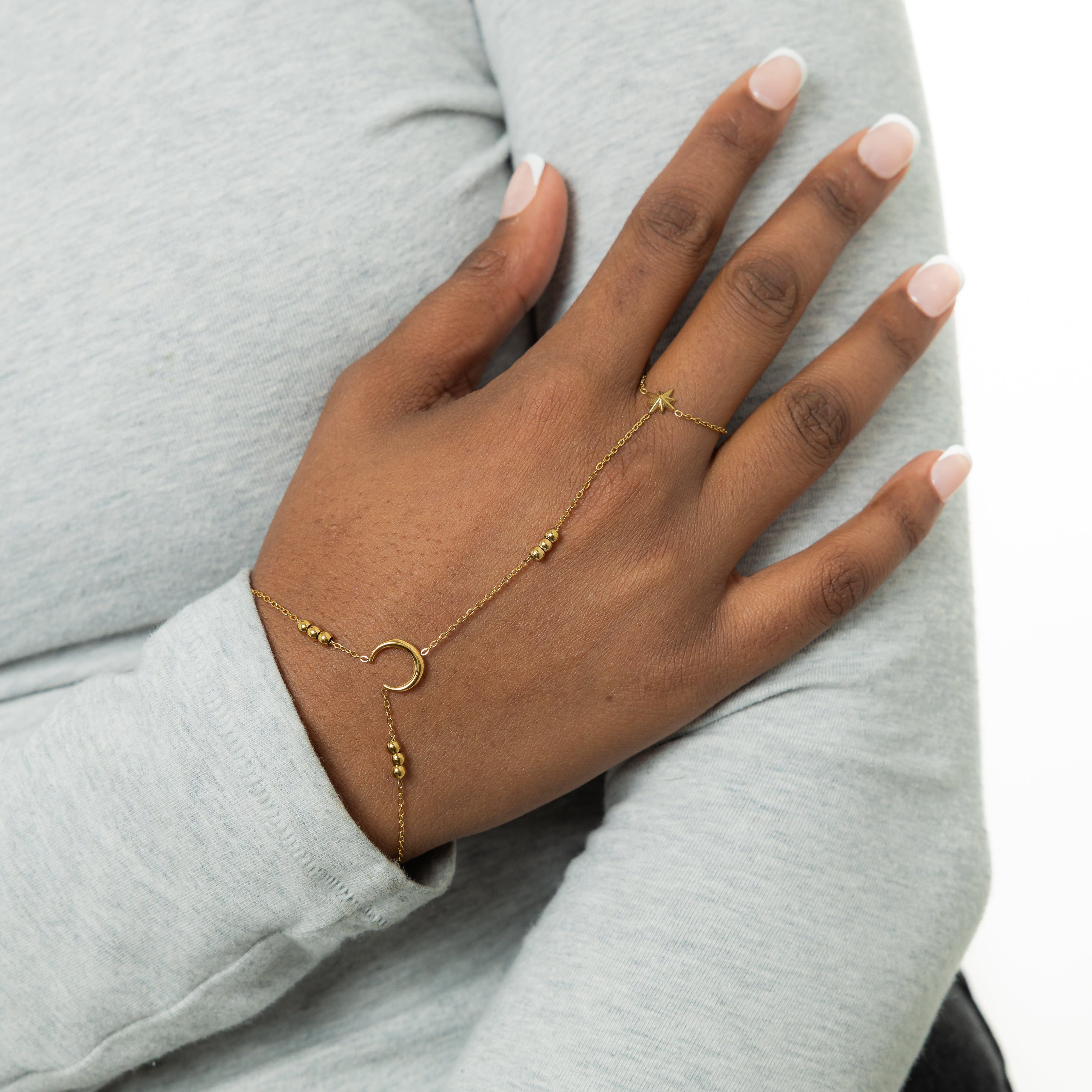 Close-up of the celestial gold hand chain highlighting the intricate orb clusters.