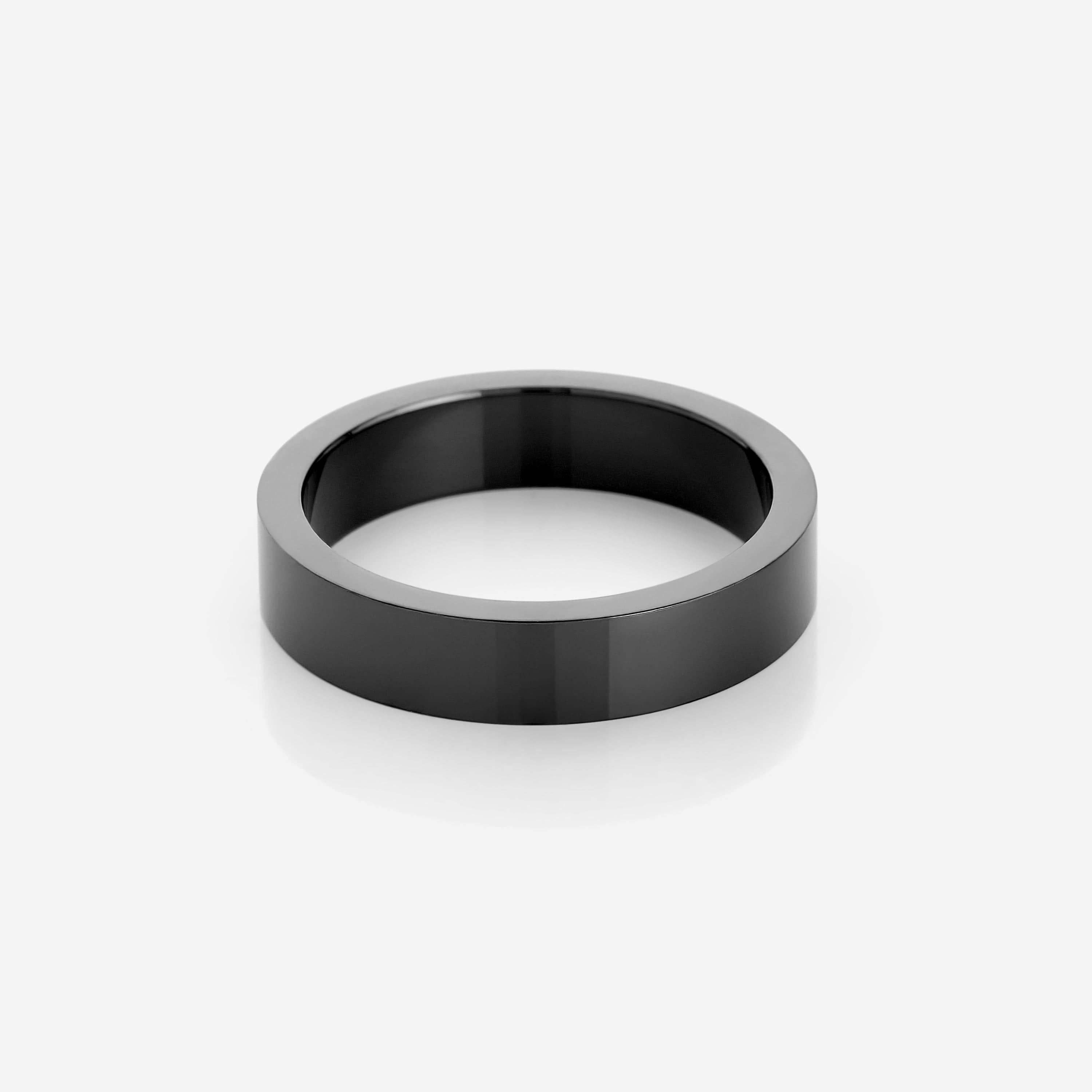 The Essential Minimalist Steel Ring presented in a velvet drawstring pouch, emphasizing its premium packaging.
