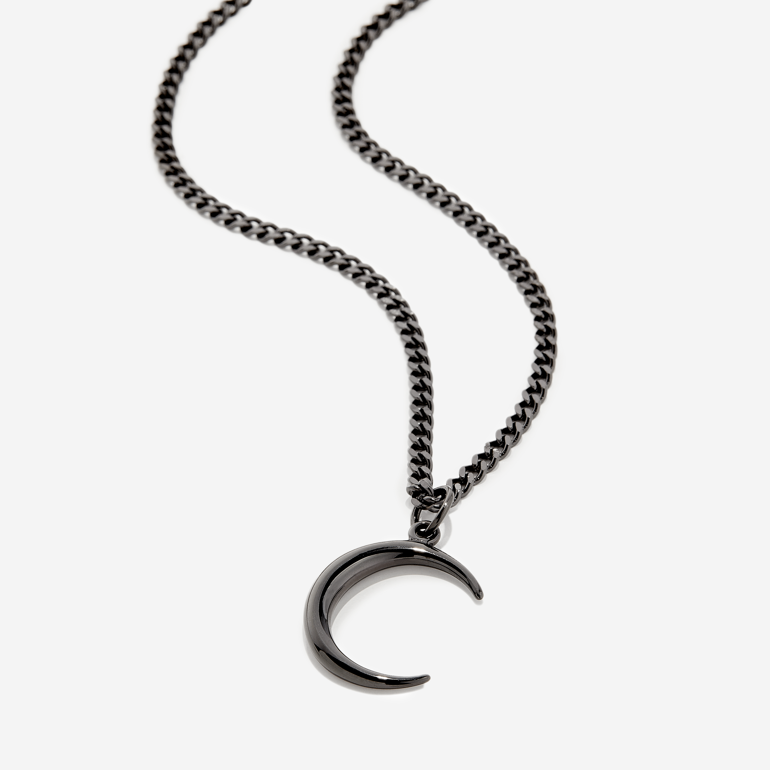 Close-up of the stainless steel crescent pendant highlighting its 3D design.