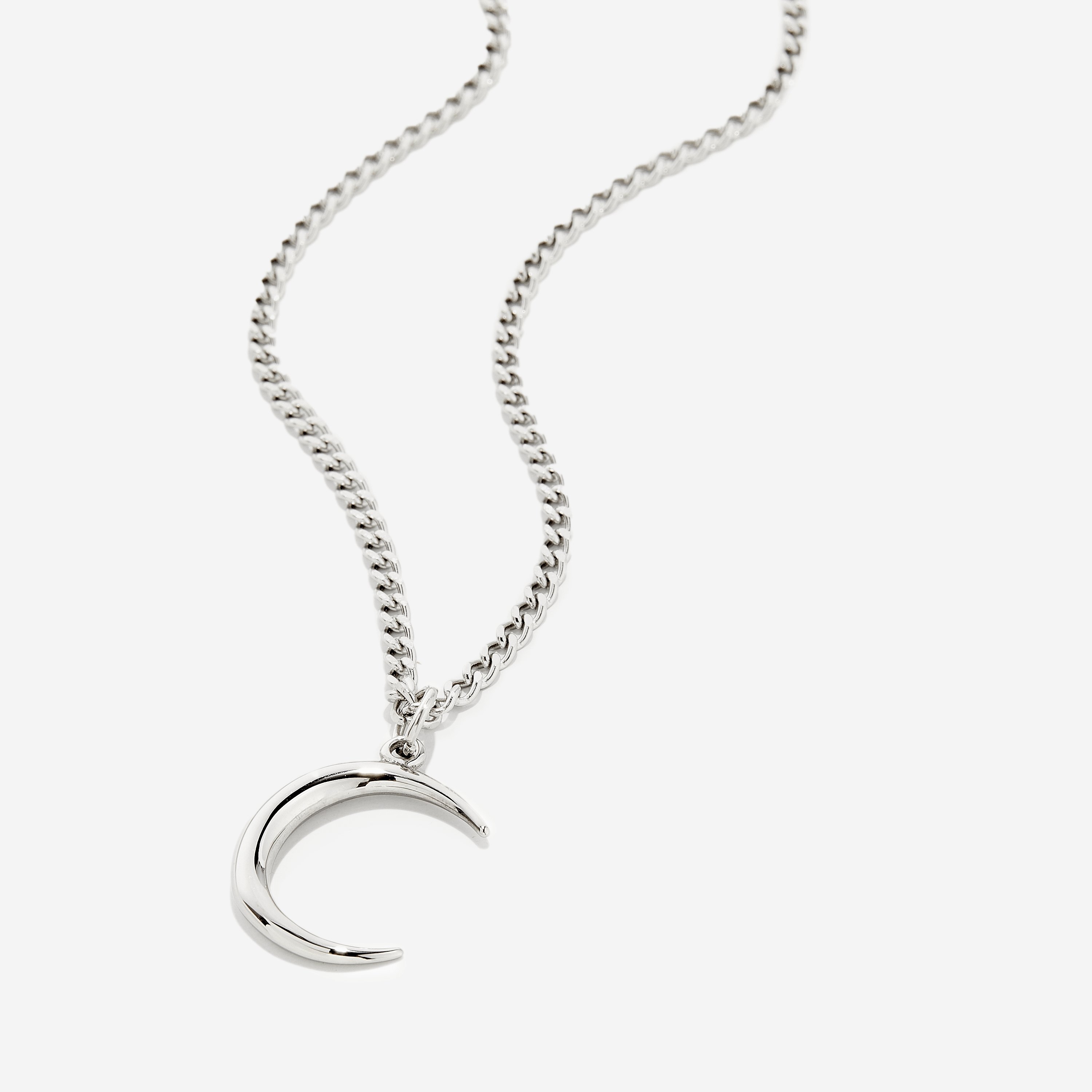Elegant crescent necklace for men displayed on a wooden table.