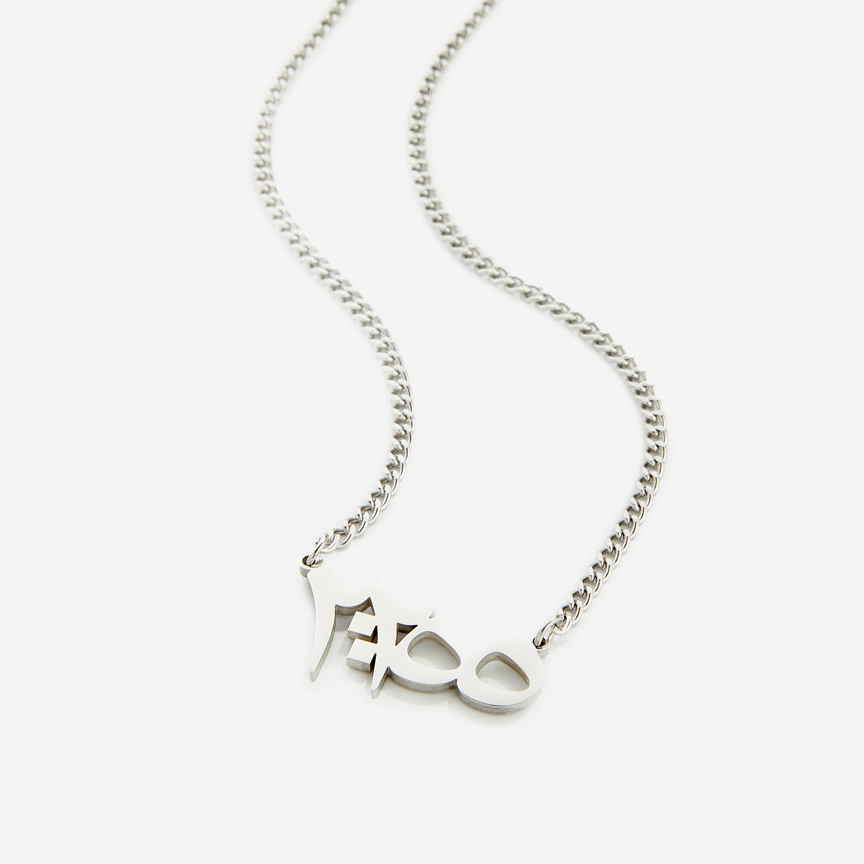 Close-up of Ayatul Kursi pendant necklace showcasing intricate Arabic calligraphy.