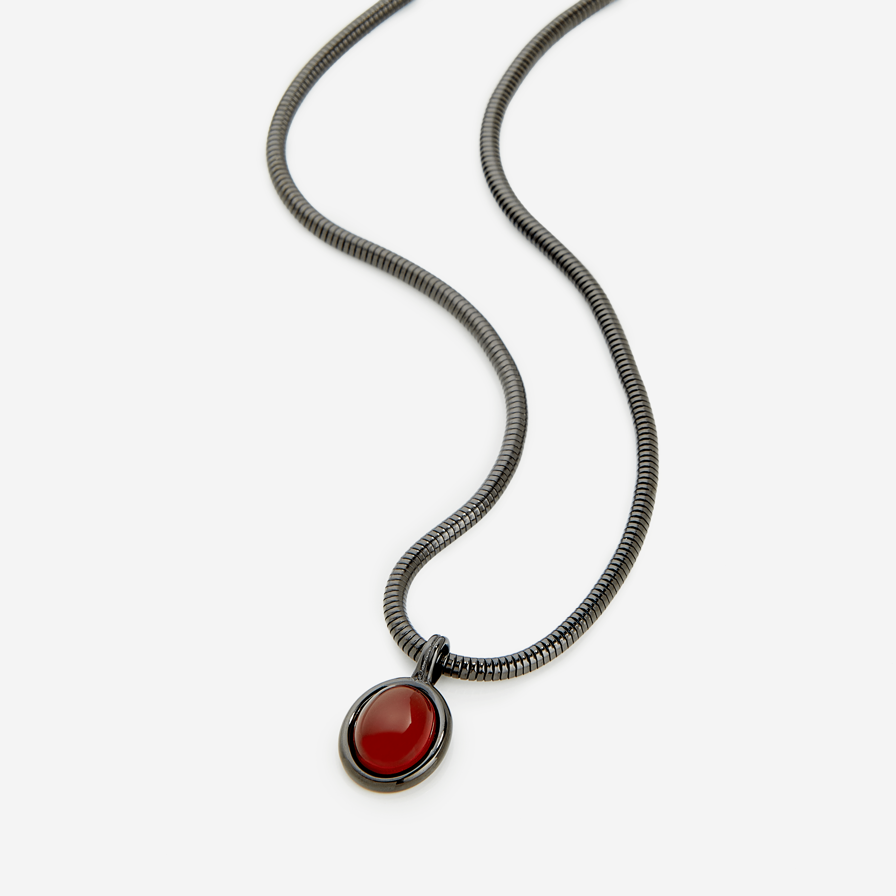 Close-up of the red agate stone in the steel pendant, highlighting its rich color and craftsmanship.