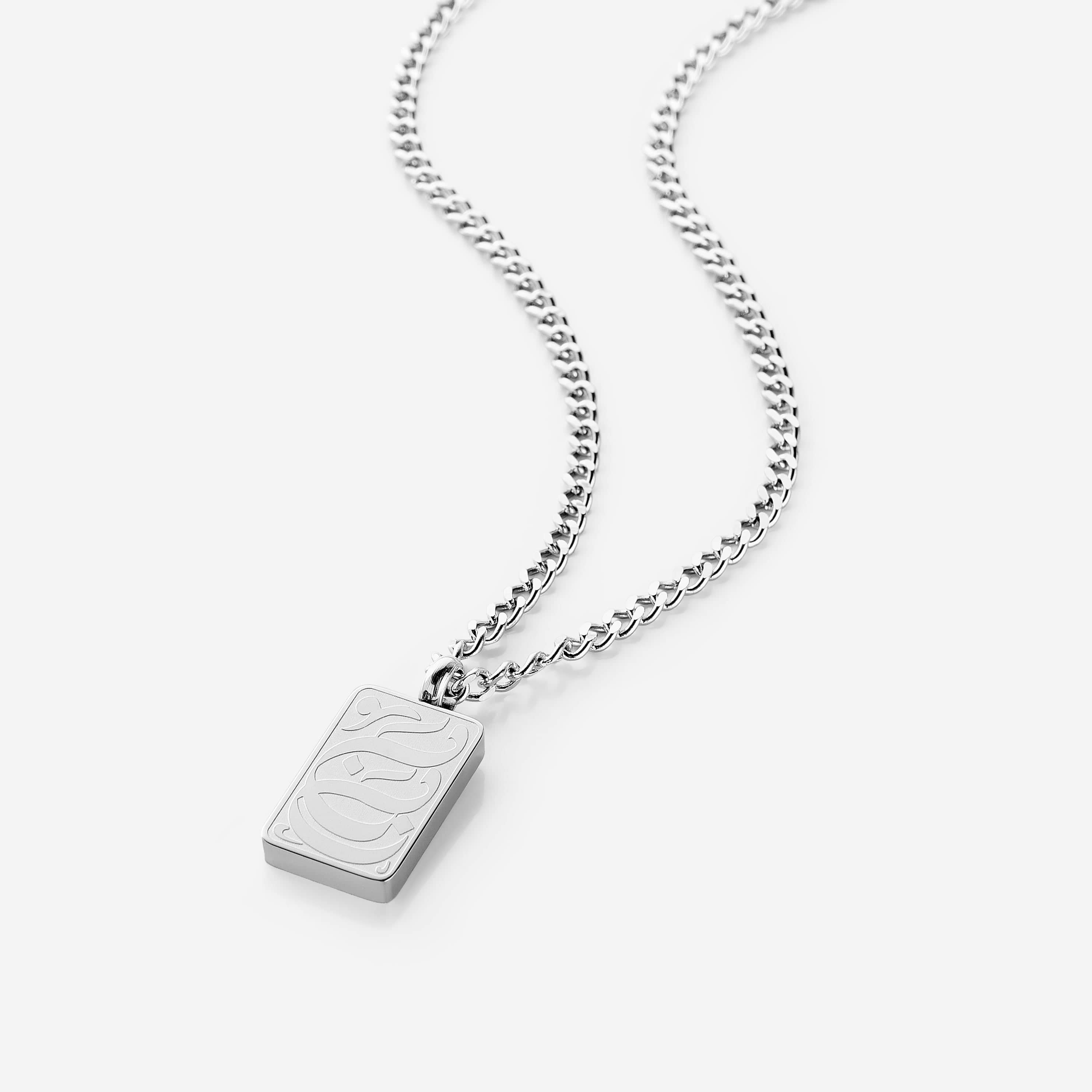 Close-up view of Baba engraved tag necklace showcasing Arabic engraving.