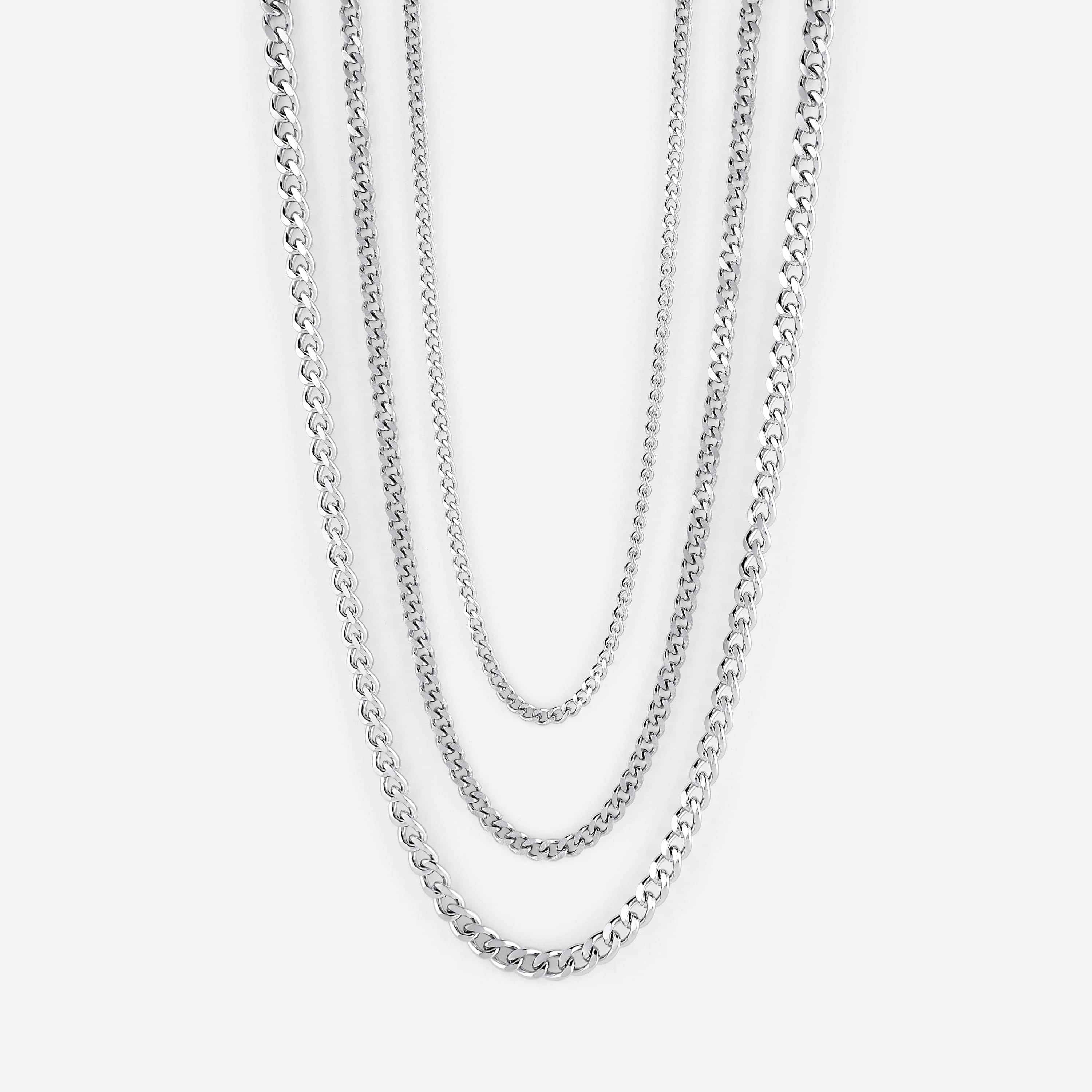 Close-up of 4mm EdgeLink™ stainless steel curb chain shown on a wooden surface, highlighting uniform link texture