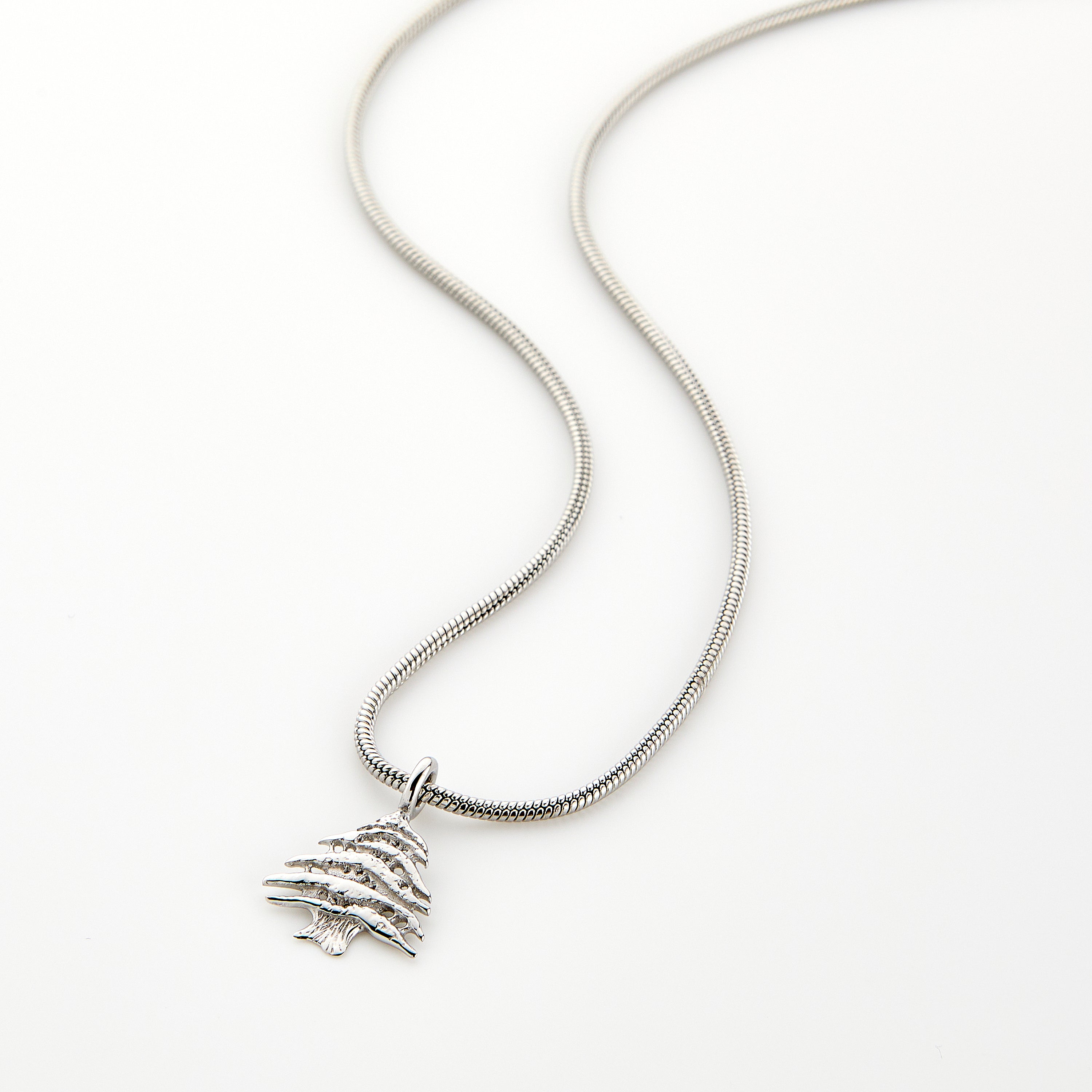 Cedar of Lebanon men's necklace hanging on display, showcasing its stainless steel shine and intricate design.