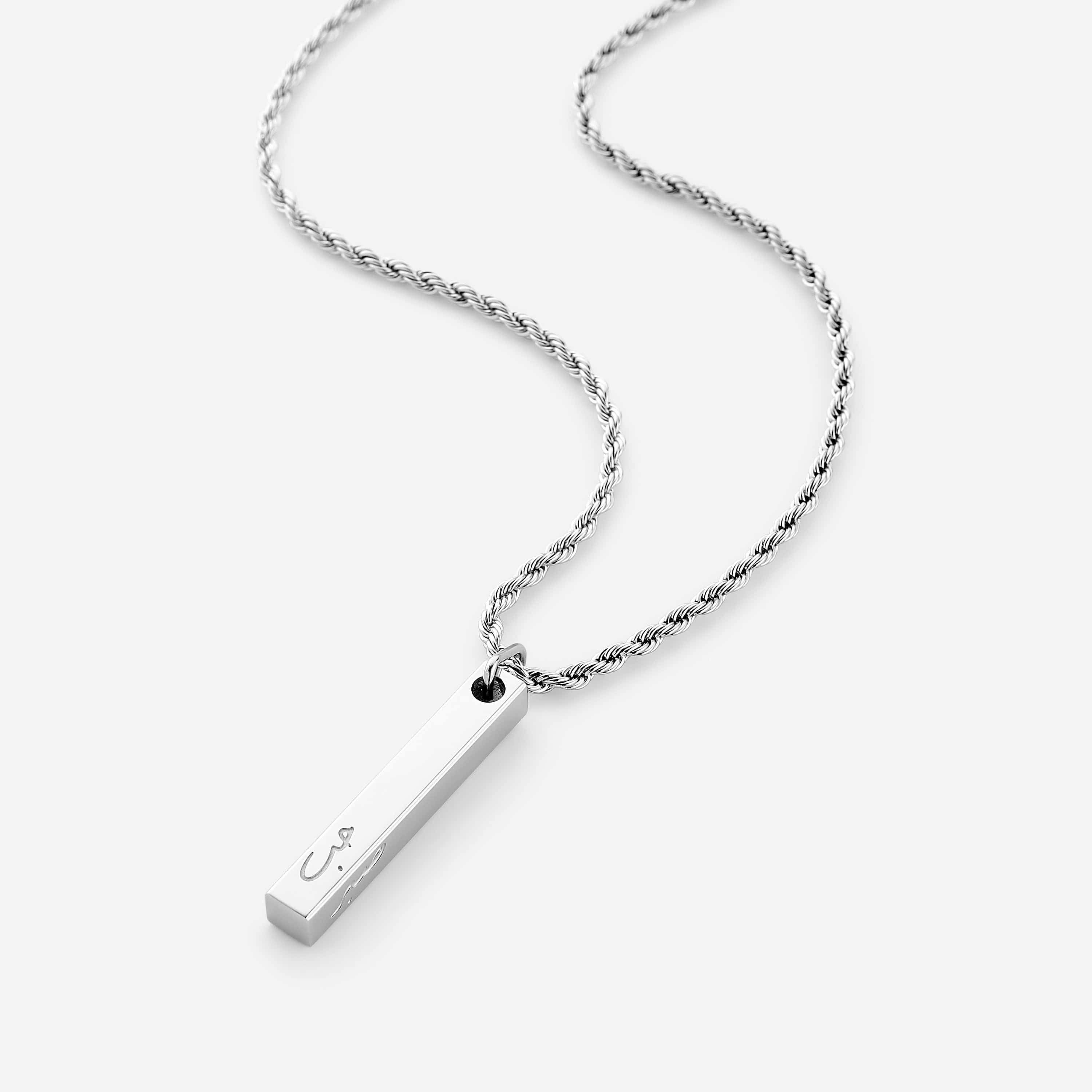 Close-up of the Core Values engraved bar necklace showcasing peace, love, faith, and patience engravings.