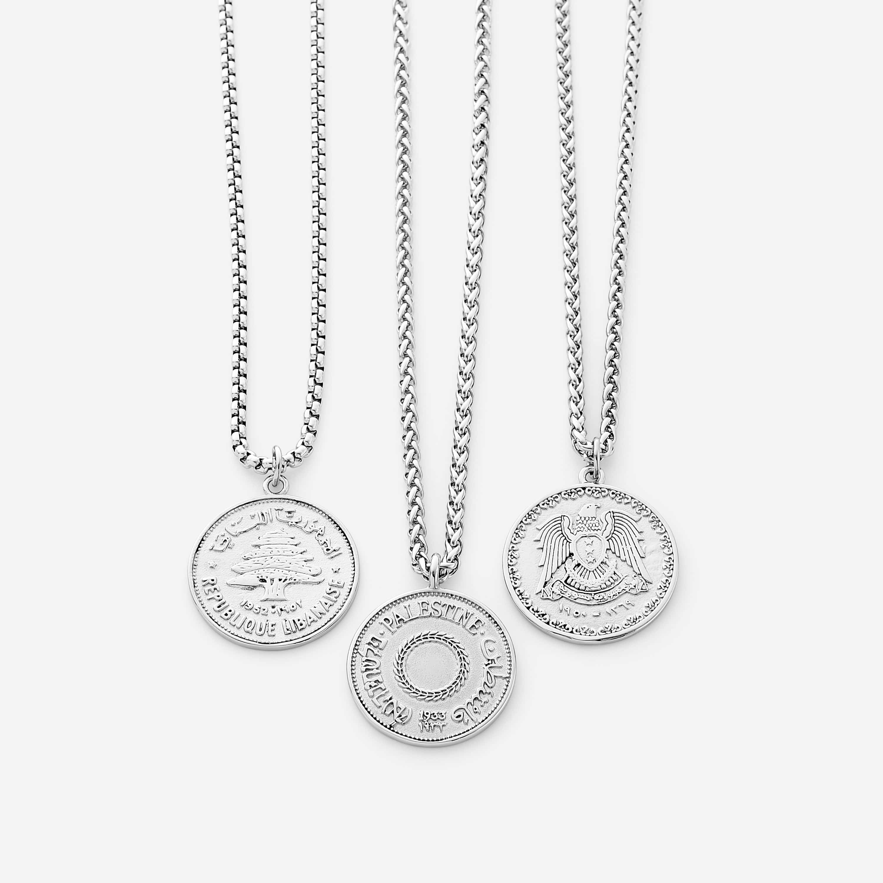 Front view of the authentic country coin necklace on a dark background, highlighting its wheat chain and pendant.