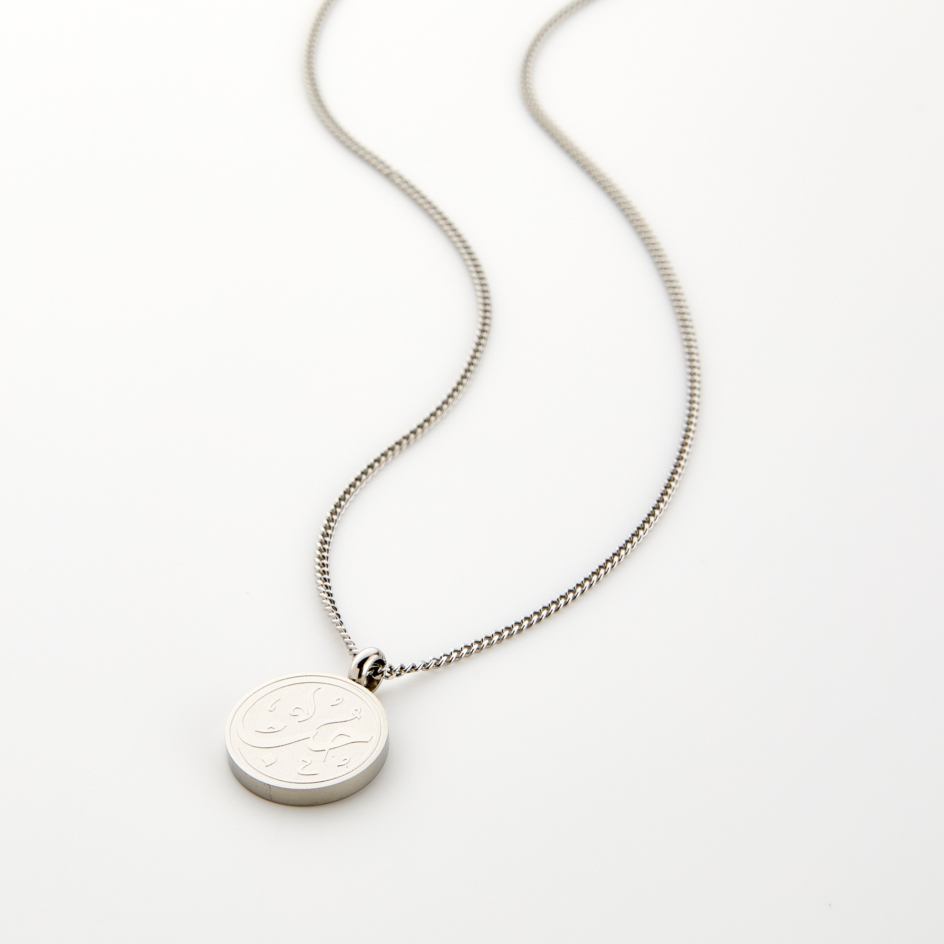 Close-up view of the Arabic calligraphy love necklace for men showcasing its intricate design.