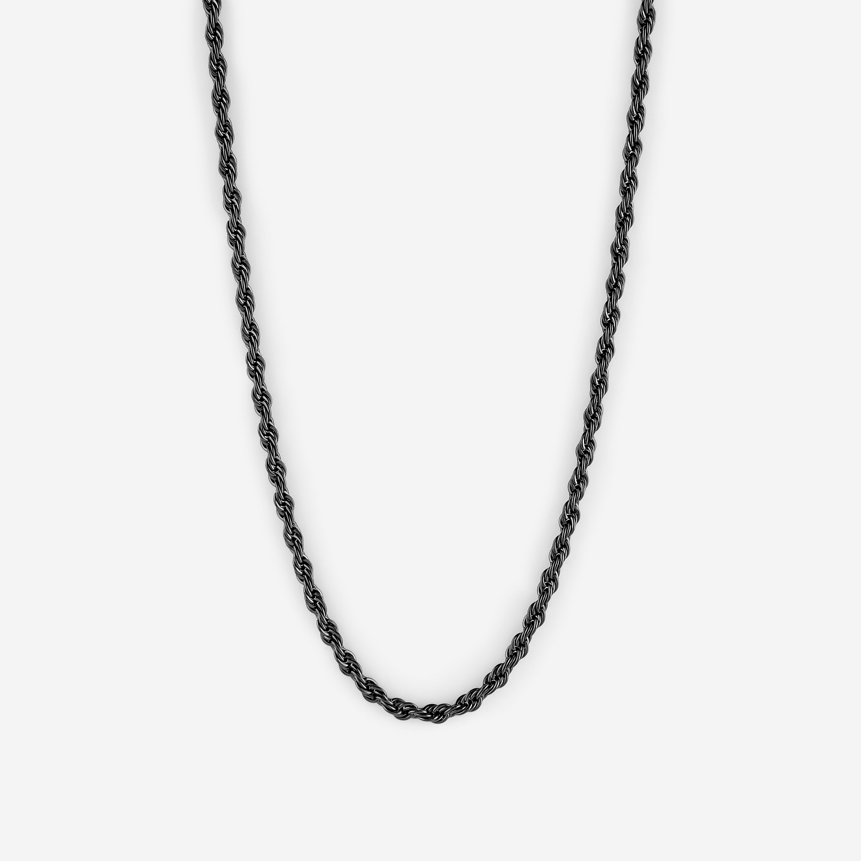 Flat lay showing 3mm rope chain alongside Nominal velvet pouch packaging