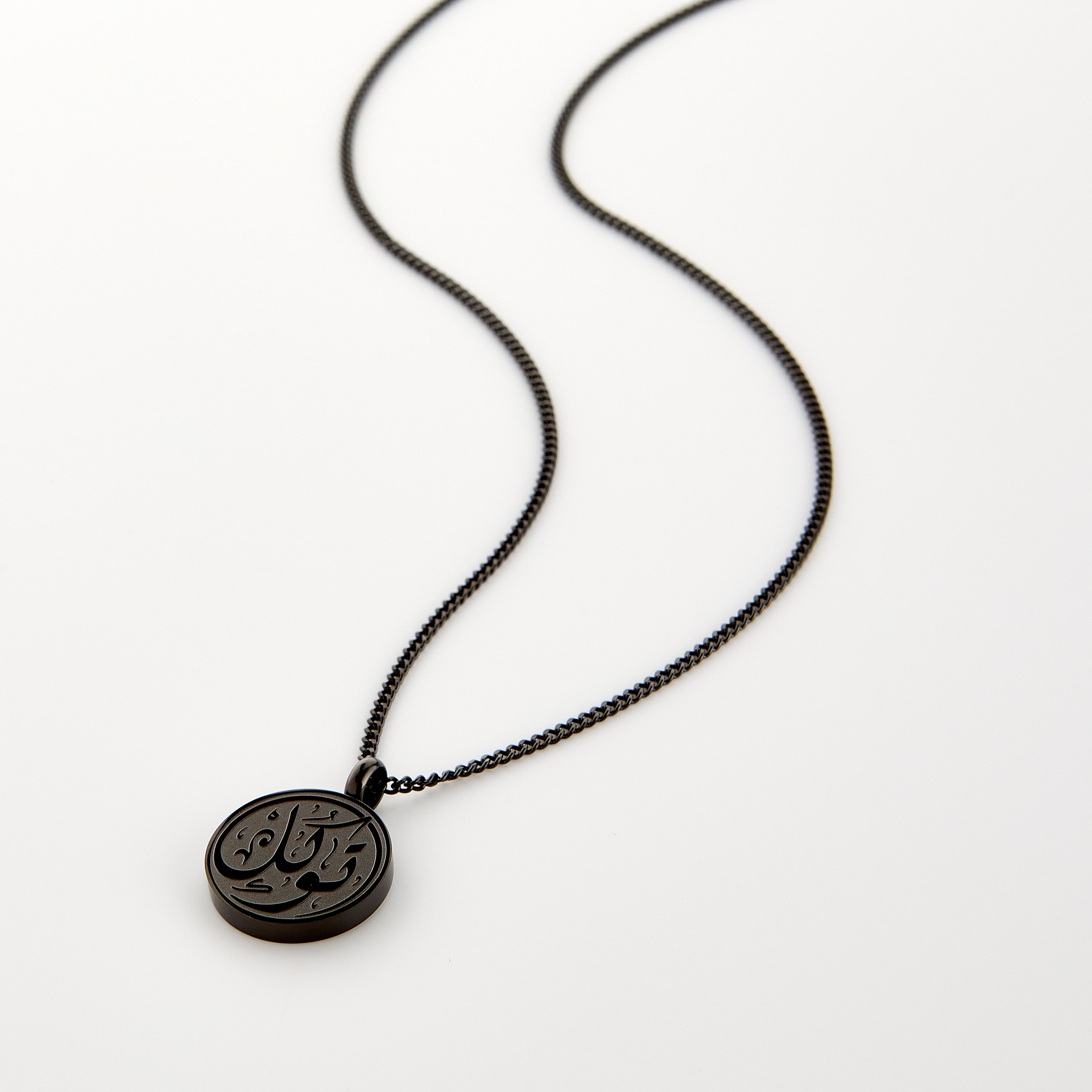 Men wearing a stylish trust pendant with Arabic calligraphy in various settings.