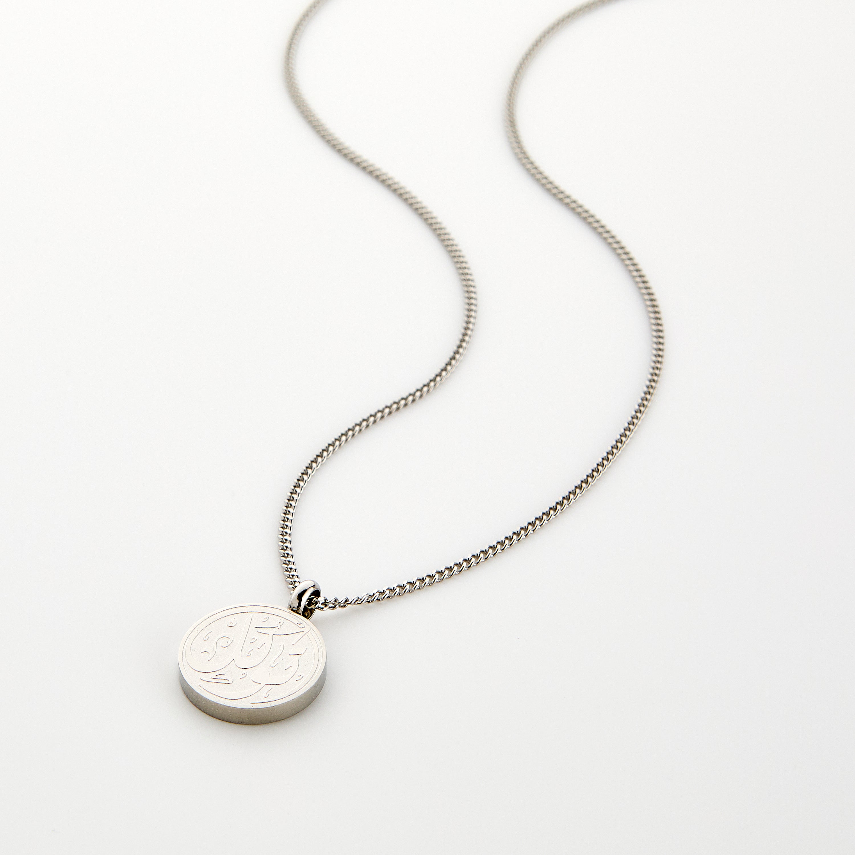 Elegant trust necklace for men showcasing Arabic calligraphy from a side angle.