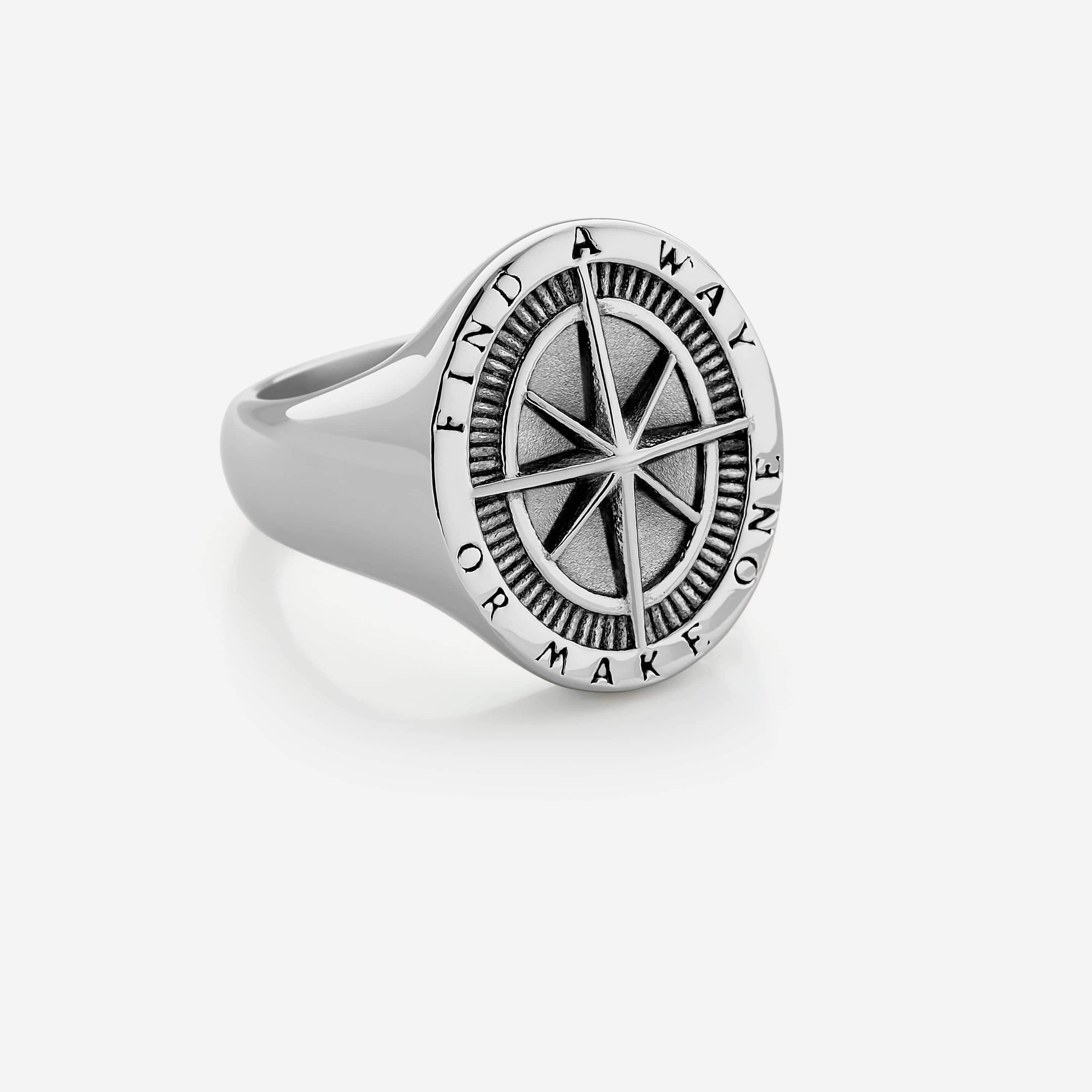 Front view of the Pathfinder stainless steel compass ring, showcasing its embossed design.