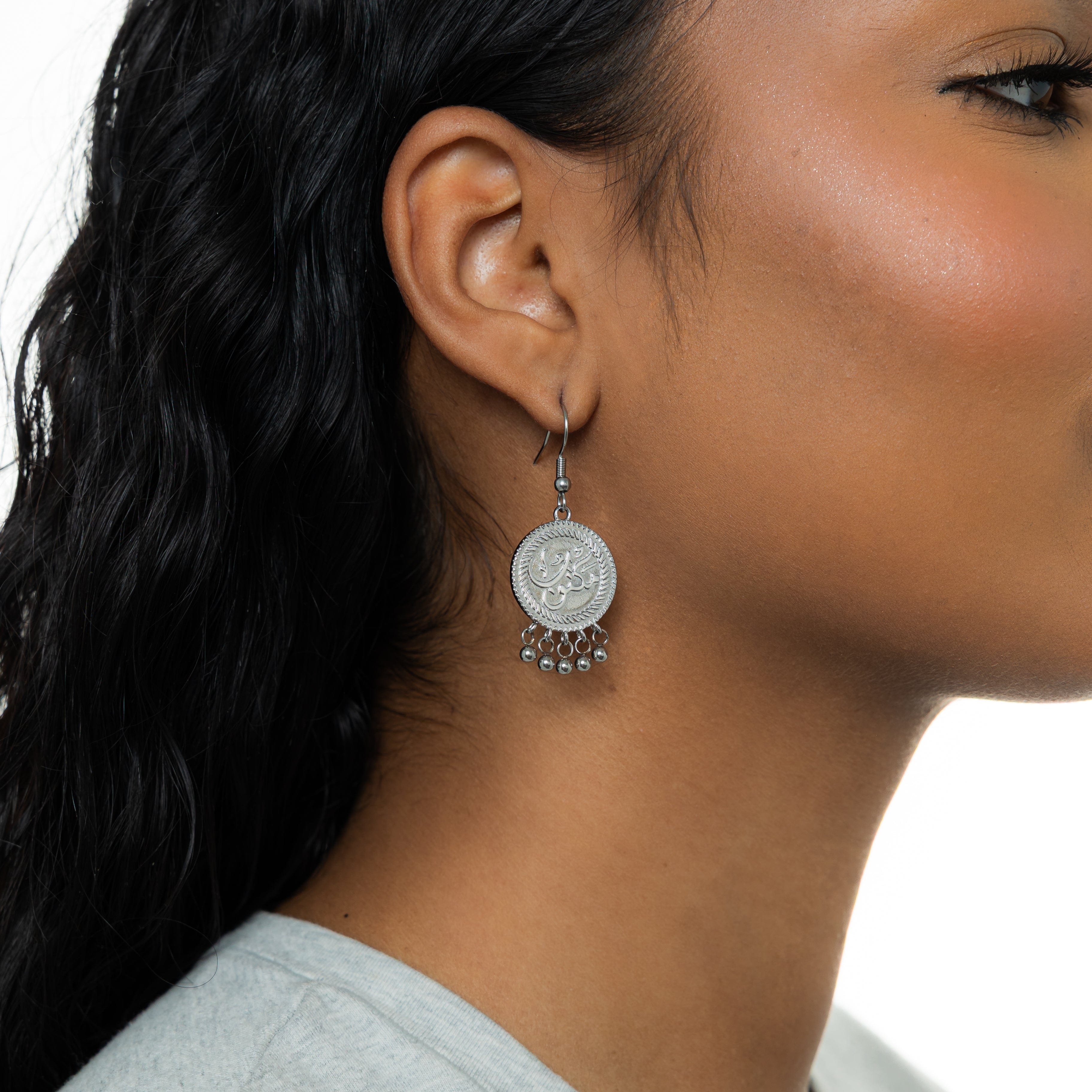 Detailed view of Heritage Charm Vintage Coin Earrings showcasing the intricate Arabic engraving.