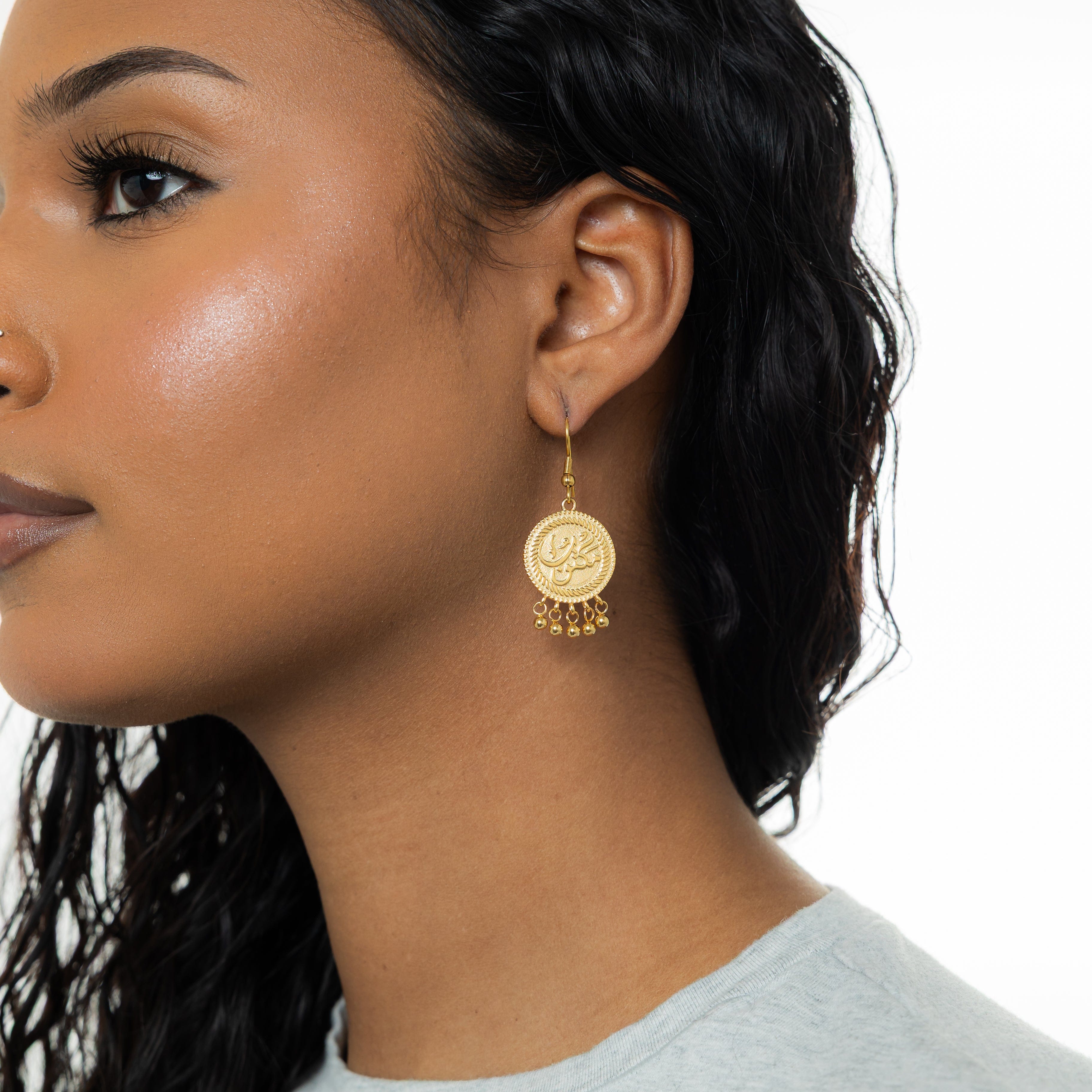 Lifestyle shot of vintage coin earrings being worn, highlighting their movement and shimmer.