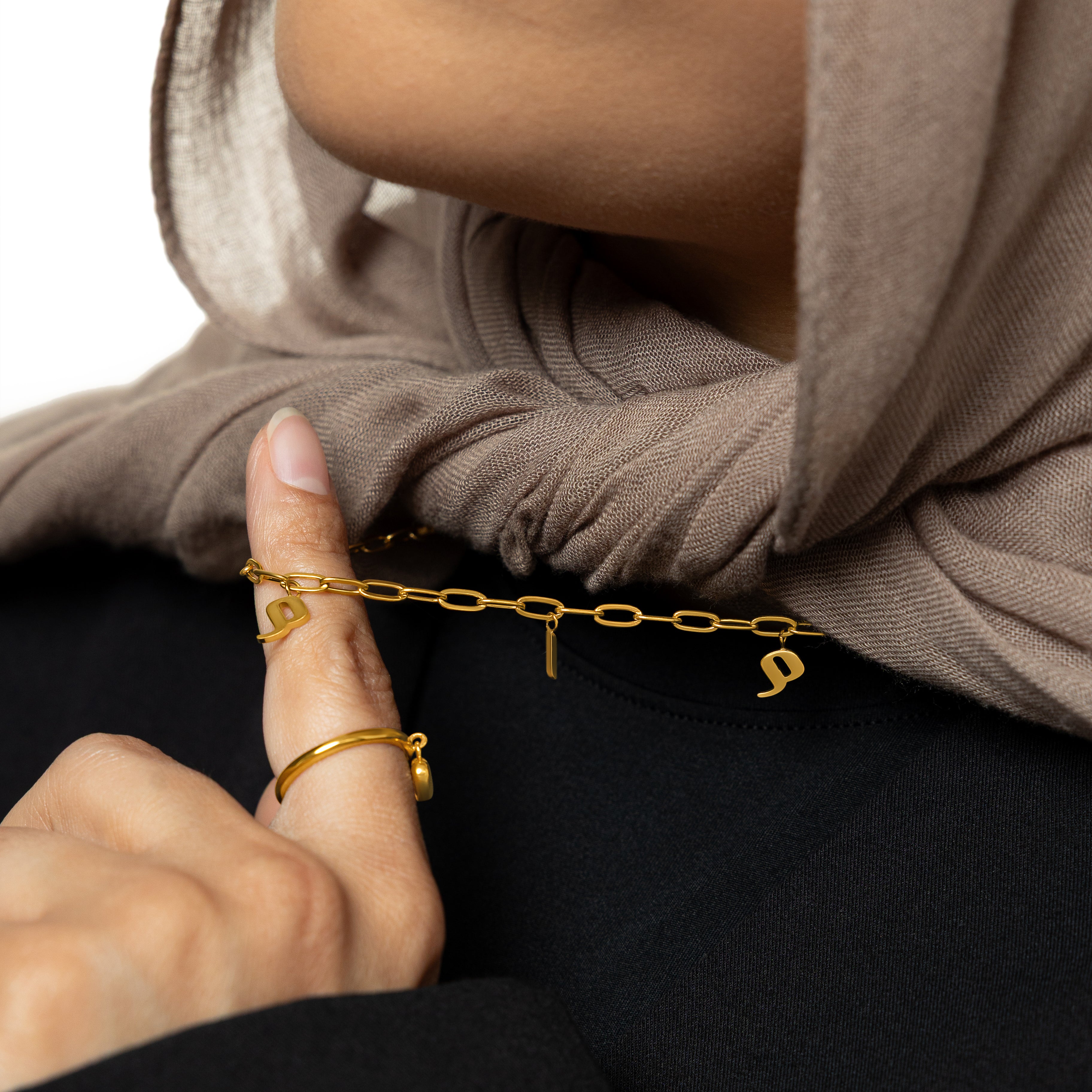 A woman wearing the personalized mama charm necklace, highlighting its beautiful design.