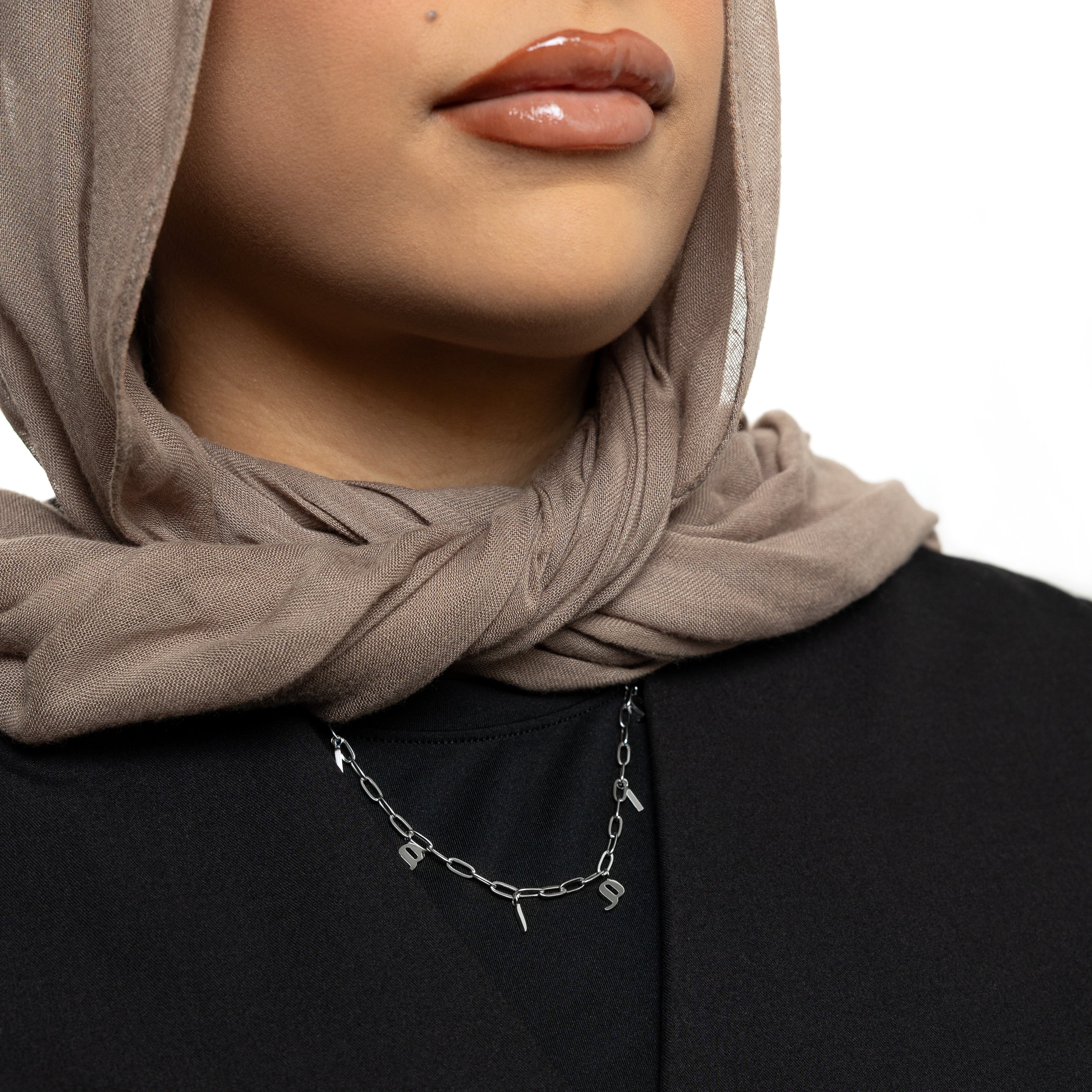 A woman wearing the personalized mama charm necklace, highlighting its beautiful design.