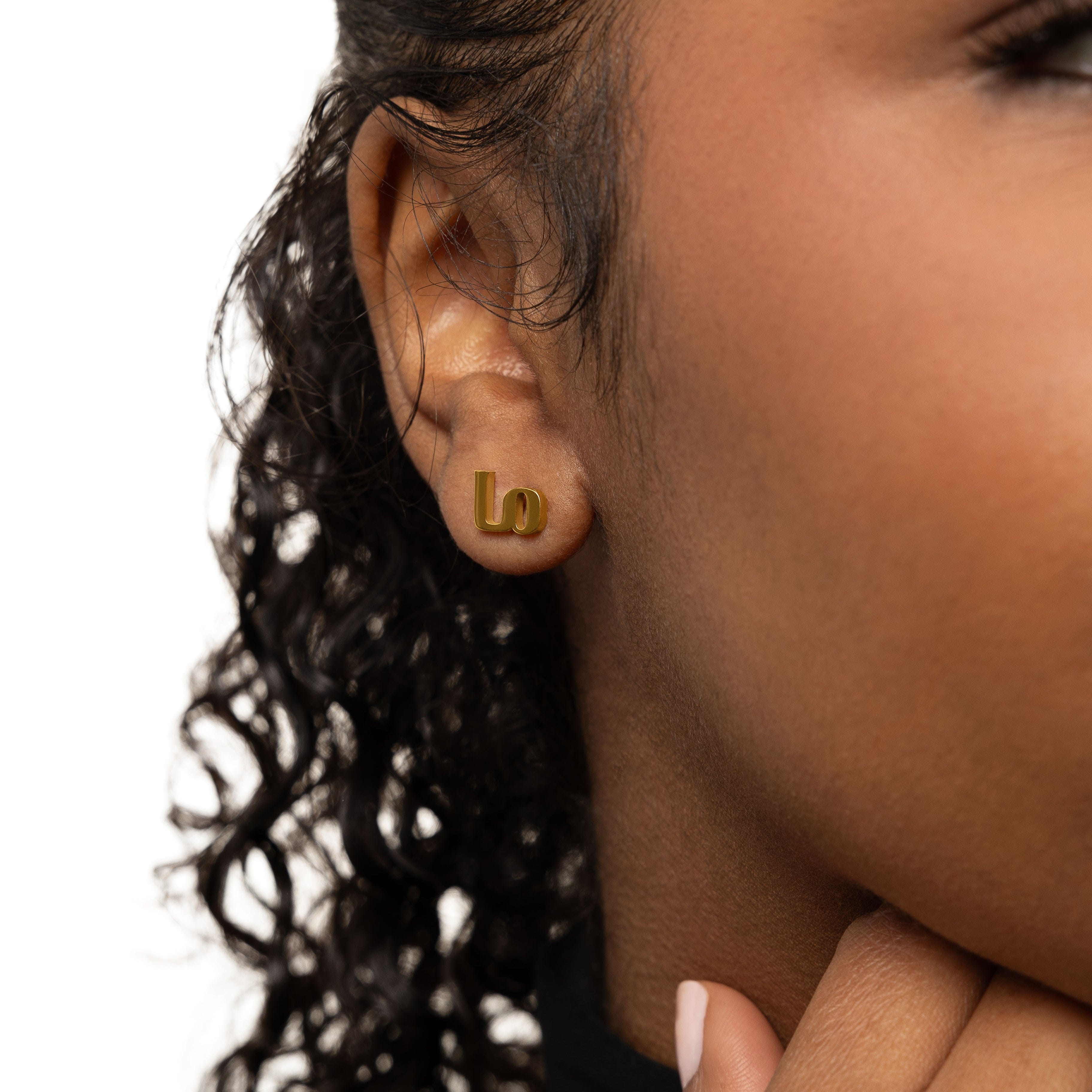 Close-up view of Mama Love minimalist earrings showcasing Arabic calligraphy.