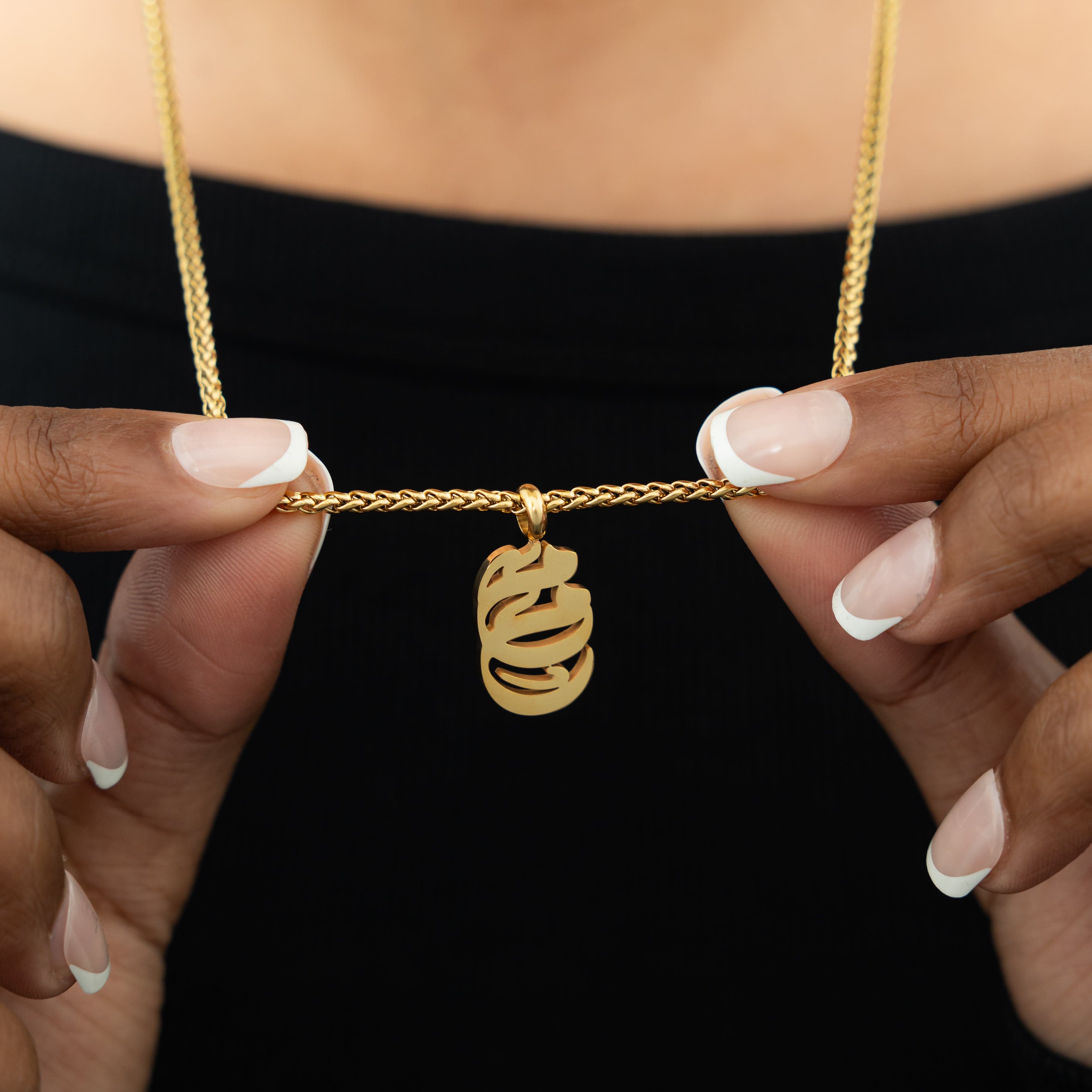 Close-up of the Mama Oval Necklace highlighting the intricate Arabic calligraphy.