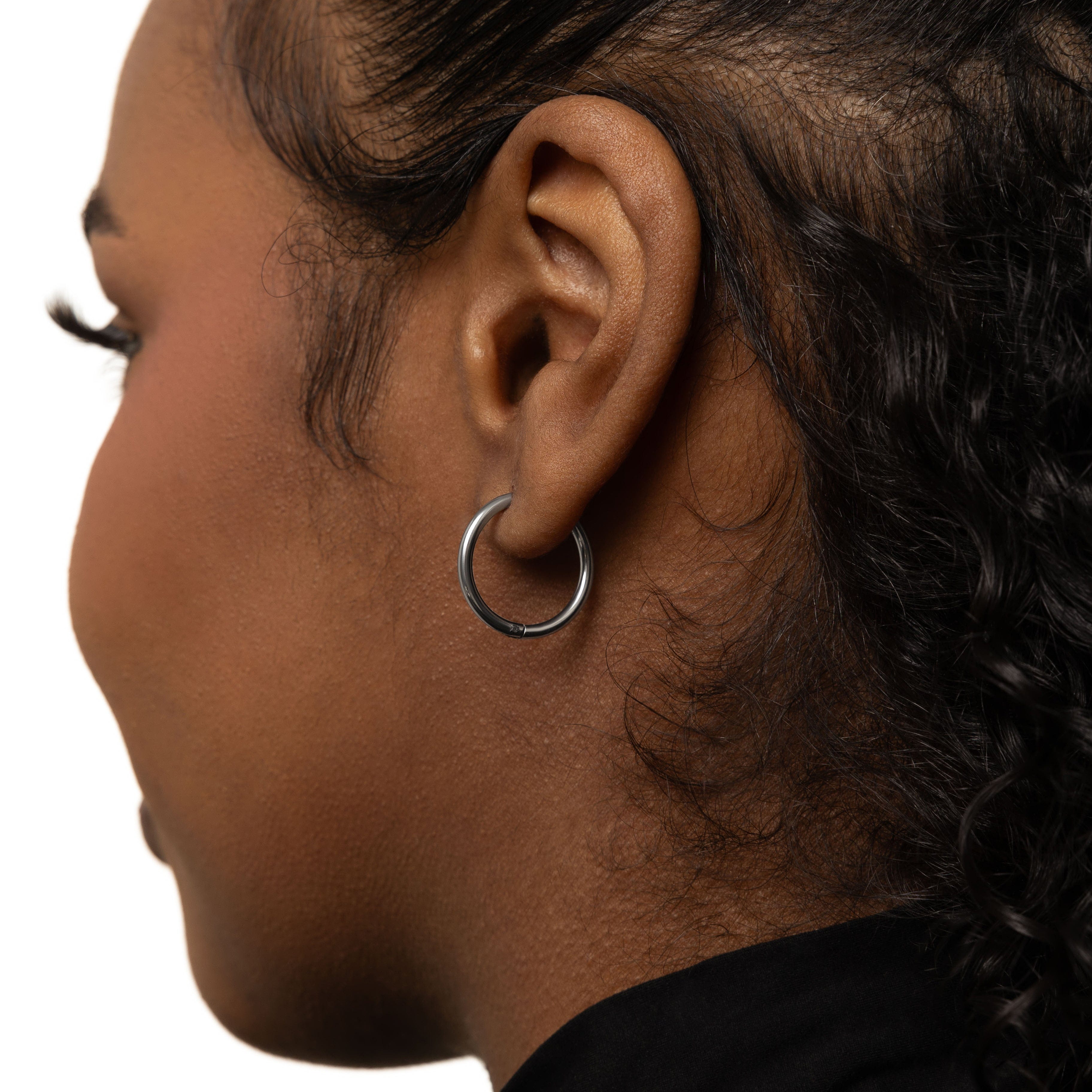 Close-up of the 16mm medium hoops worn, demonstrating their versatility with casual attire.