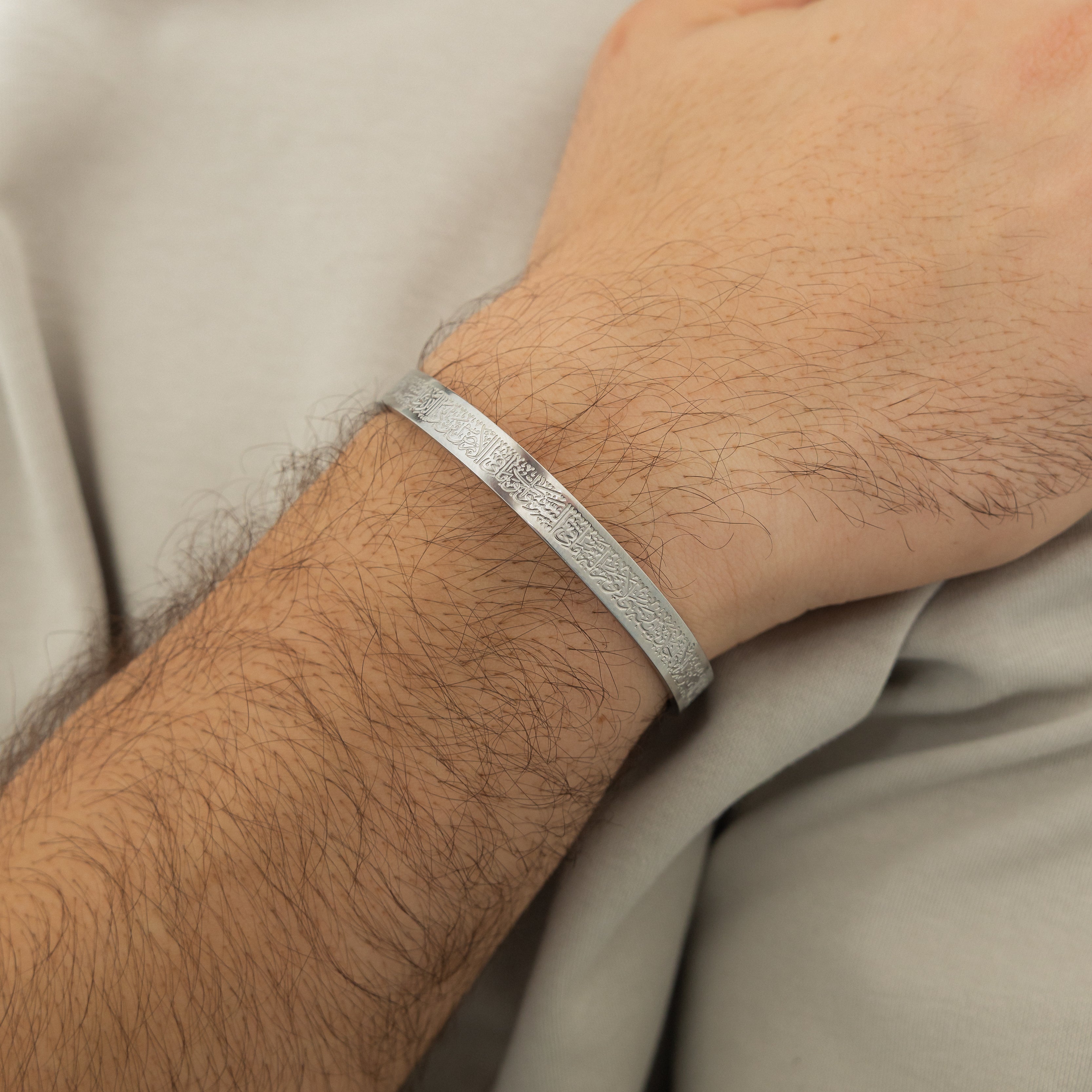 Man wearing the engraved cuff, demonstrating its stylish appeal and comfort.