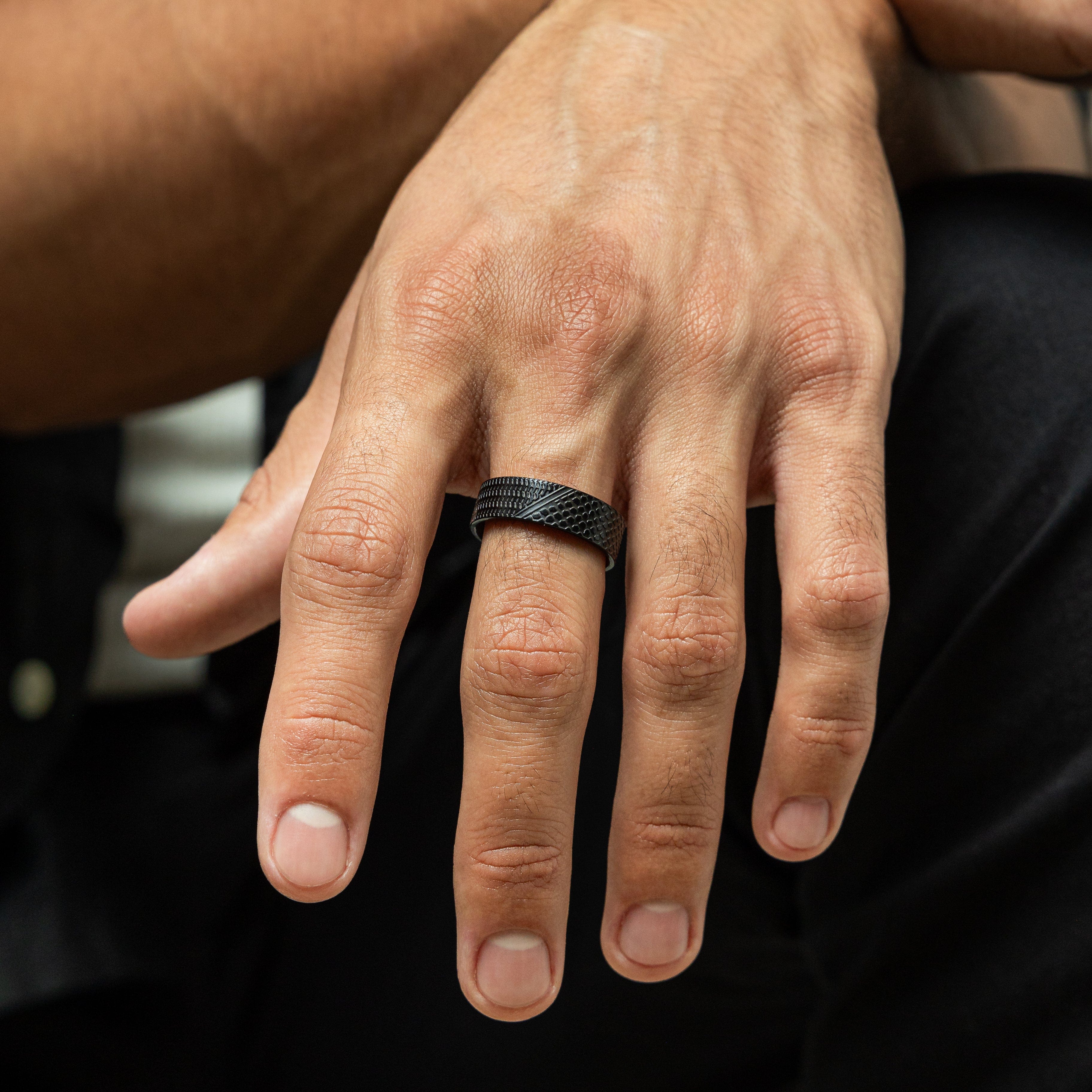 Mens keffiyeh ring displayed on a hand, highlighting its intricate design and stainless steel finish.