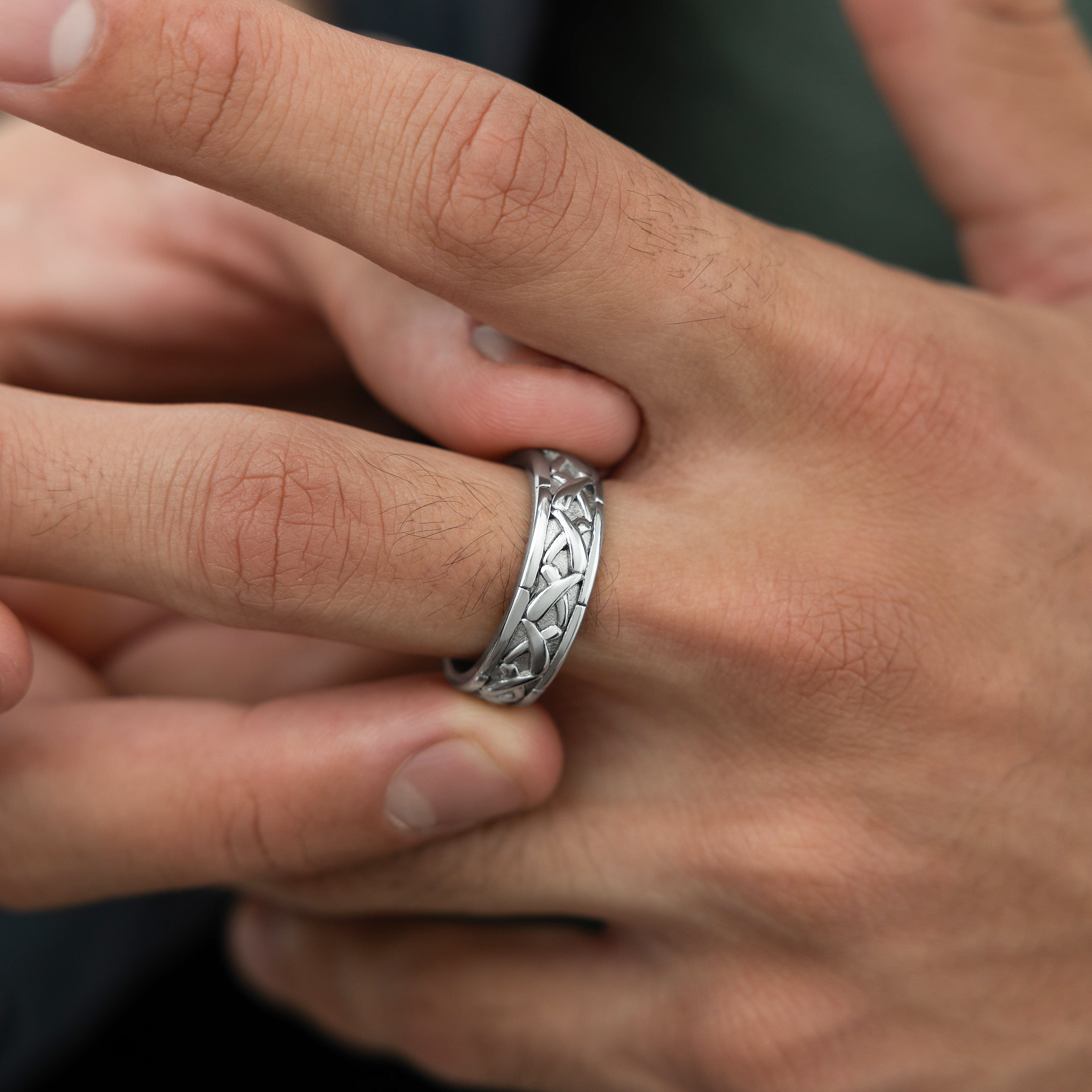 Lifestyle image of a man wearing the Emblem of Legacy Ring at a social gathering, representing modern style.